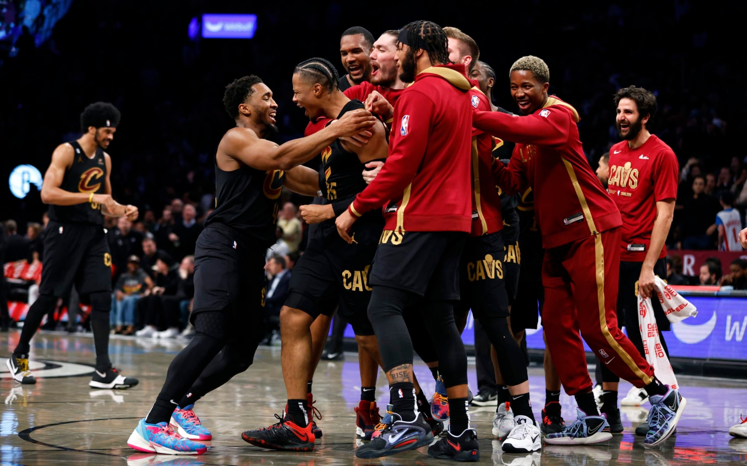 Cleveland Cavaliers guard Donovan Mitchell, front left, congratulates forward Isaac Okoro, second from front left, after making the winning basket against the Brooklyn Nets during the second half of an NBA basketball game, Thursday, March 23, 2023, in New York. (AP Photo/Noah K. Murray)