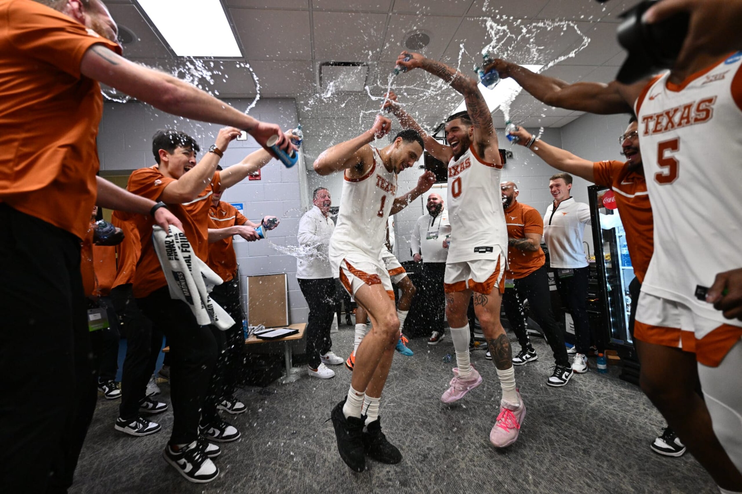 DES MOINES, IA - MARCH 18: Dylan Disu #1, Timmy Allen #0 and Marcus Carr #5 of the Texas Longhorns celebrate their 71-66 victory over the Penn State Nittany Lions during the second round of the 2023 NCAA Men's Basketball Tournament held at Wells Fargo Arena on March 18, 2023 in Des Moines, Iowa. (Photo by Jamie Sabau/NCAA Photos via Getty Images)