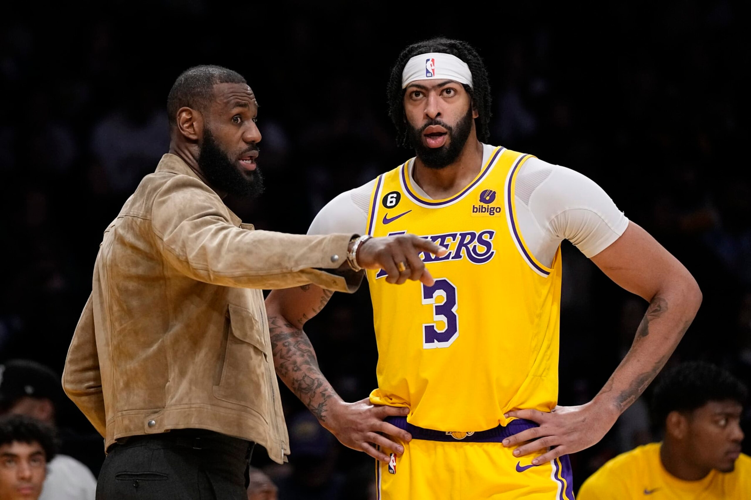Los Angeles Lakers' LeBron James, left, talks with forward Anthony Davis during the second half of an NBA basketball game against the Phoenix Suns Wednesday, March 22, 2023, in Los Angeles. (AP Photo/Mark J. Terrill)