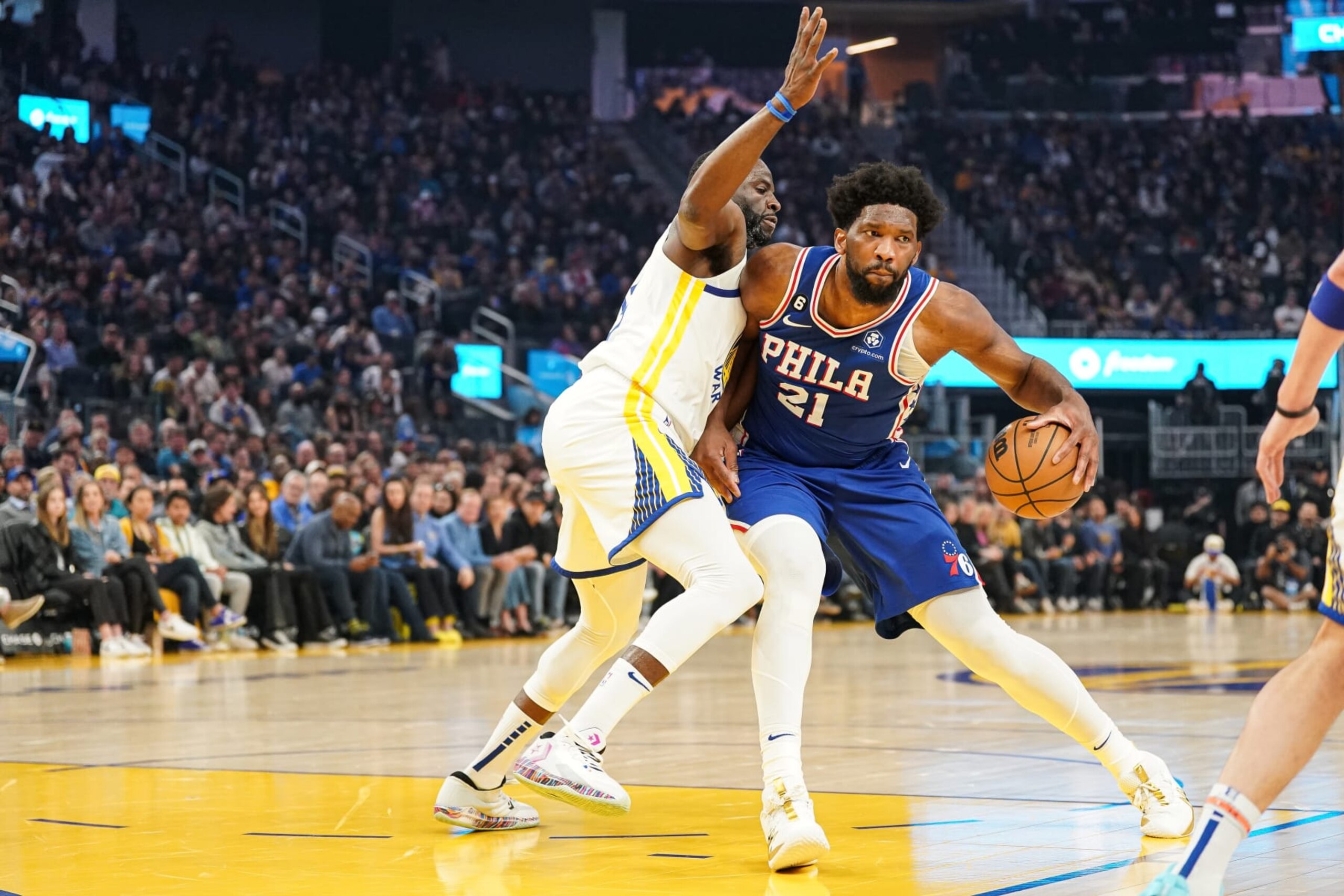 SAN FRANCISCO, CA - MARCH 24: Joel Embiid #21 of the Philadelphia 76ers dribbles the ball in the first quarter against Draymond Green #23 of the Golden State Warriors at Chase Center on March 24, 2023 in San Francisco, California. NOTE TO USER: User expressly acknowledges and agrees that, by downloading and/or using this photograph, User is consenting to the terms and conditions of the Getty Images License Agreement. (Photo by Kavin Mistry/Getty Images)