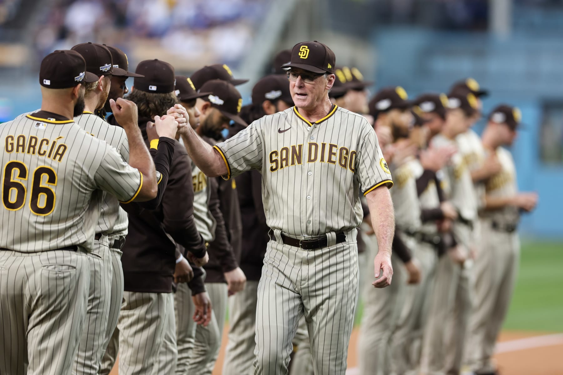 LOS ANGELES, CA - OCTOBER 11:   Manager Bob Melvin #3 of the San Diego Padres fist bumps members of his team before the game between the San Diego Padres and the Los Angeles Dodgers at Dodgers Stadium on Tuesday, October 11, 2022 in Los Angeles, California. (Photo by Rob Leiter/MLB Photos via Getty Images)