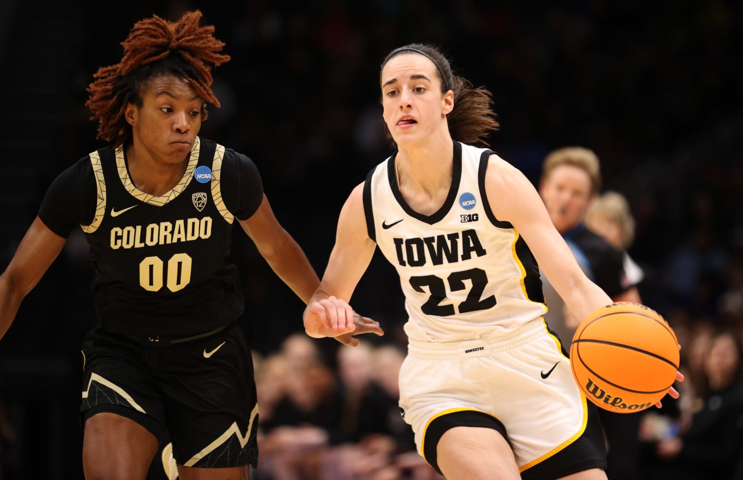 SEATTLE, WA - MARCH 24: Iowa Hawkeyes guard Caitlin Clark #22 dribbles the ball past Colorado Buffaloes guard Jaylyn Sherrod #0 during the Sweet Sixteen round of the 2023 NCAA Womens Basketball Tournament held at Climate Pledge Arena on March 24, 2023 in Seattle, Washington. (Photo by C. Morgan Engel/NCAA Photos via Getty Images) SEATTLE, WA - MARCH 24: Iowa Hawkeyes guard Caitlin Clark #22 dribbles the ball past Colorado Buffaloes guard Jaylyn Sherrod #0 during the Sweet Sixteen round of the 2023 NCAA Womens Basketball Tournament held at Climate Pledge Arena on March 24, 2023 in Seattle, Washington. (Photo by C. Morgan Engel/NCAA Photos via Getty Images)