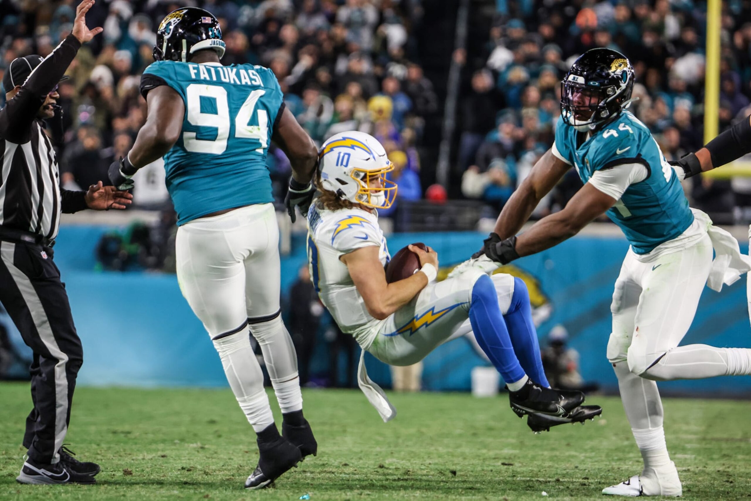 Jacksonville, Florida, January 14, 2023 -Los Angeles Chargers quarterback Justin Herbert (10) is knocked to the ground by Jacksonville Jaguars linebacker Travon Walker (44) for a roughing the passer penalty late in an AFC Wild Card game at TIAA Bank Field. (Robert Gauthier/Los Angeles Times via Getty Images) Jacksonville, Florida, January 14, 2023 -Los Angeles Chargers quarterback Justin Herbert (10) is knocked to the ground by Jacksonville Jaguars linebacker Travon Walker (44) for a roughing the passer penalty late in an AFC Wild Card game at TIAA Bank Field. (Robert Gauthier/Los Angeles Times via Getty Images)
