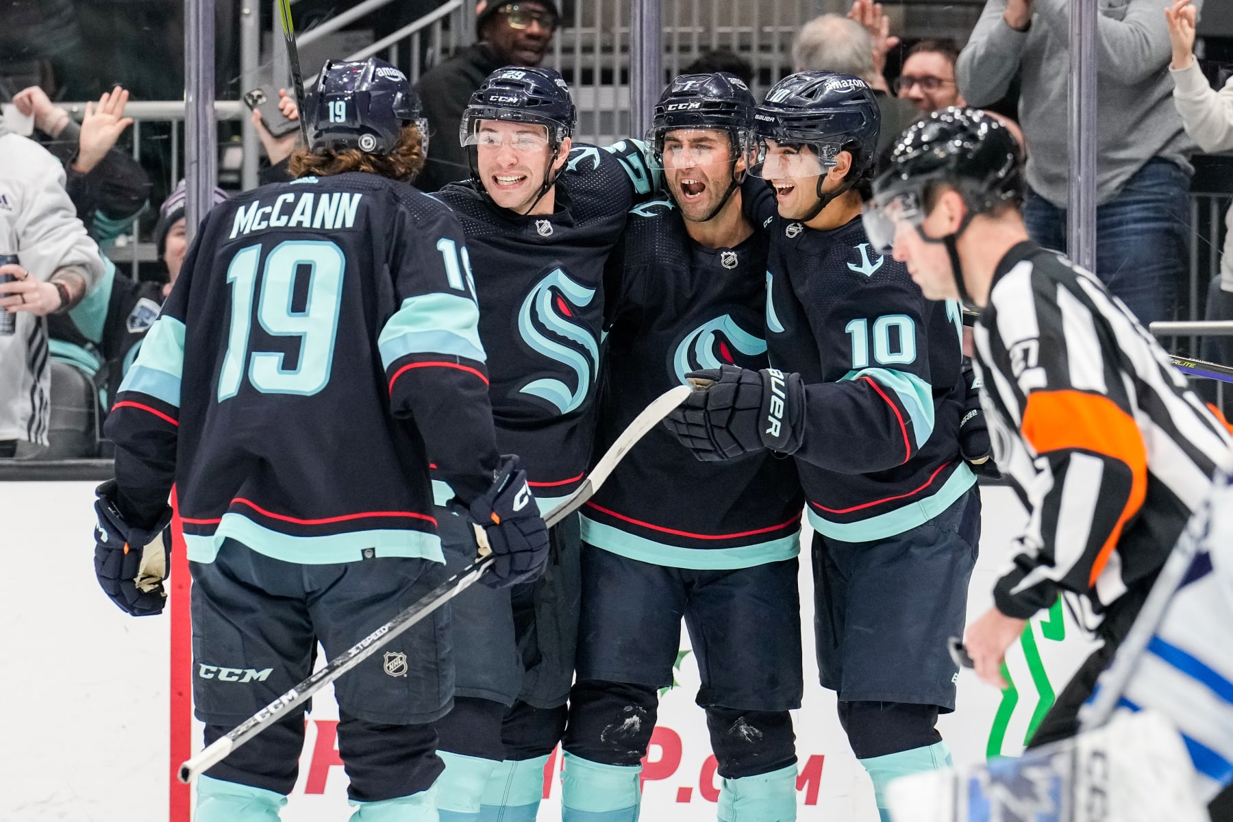 SEATTLE, WASHINGTON - DECEMBER 18: Jared McCann #19, Vince Dunn #29, Jordan Eberle #7 and Matty Beniers #10 of the Seattle Kraken celebrate a goal by Eberle during the second period of a game against the Winnipeg Jets at Climate Pledge Arena on December 18, 2022 in Seattle, Washington. (Photo by Christopher Mast/NHLI via Getty Images)