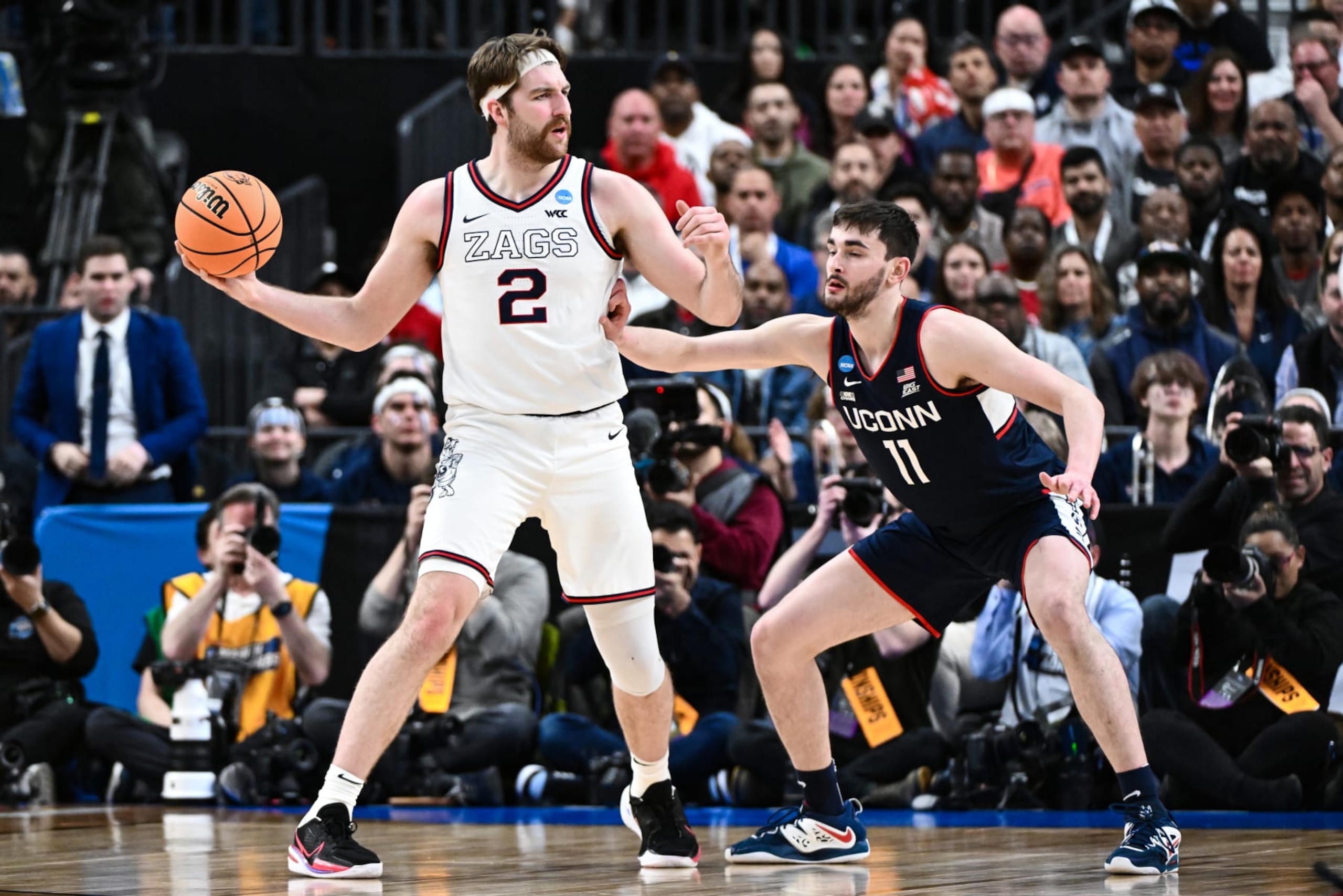 LAS VEGAS, NV - MARCH 25: Drew Timme #2 of the Gonzaga Bulldogs handles the ball against Alex Karaban #11 of the Connecticut Huskies during the Elite Eight round of the 2023 NCAA Men's Basketball Tournament held at T-Mobile Arena on March 25, 2023 in Las Vegas, Nevada. (Photo by Brett Wilhelm/NCAA Photos via Getty Images)