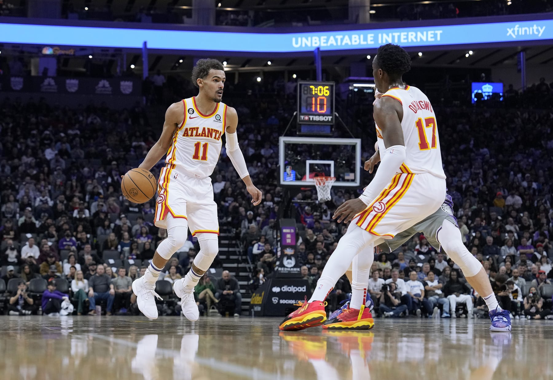 SACRAMENTO, CALIFORNIA - JANUARY 04: Trae Young #11 of the Atlanta Hawks dribbles the ball around a screen set by Onyeka Okongwu #17 on Kevin Huerter #9 of the Sacramento Kings during the third quarter of an NBA basketball game at Golden 1 Center on January 04, 2023 in Sacramento, California. NOTE TO USER: User expressly acknowledges and agrees that, by downloading and or using this photograph, User is consenting to the terms and conditions of the Getty Images License Agreement. (Photo by Thearon W. Henderson/Getty Images)