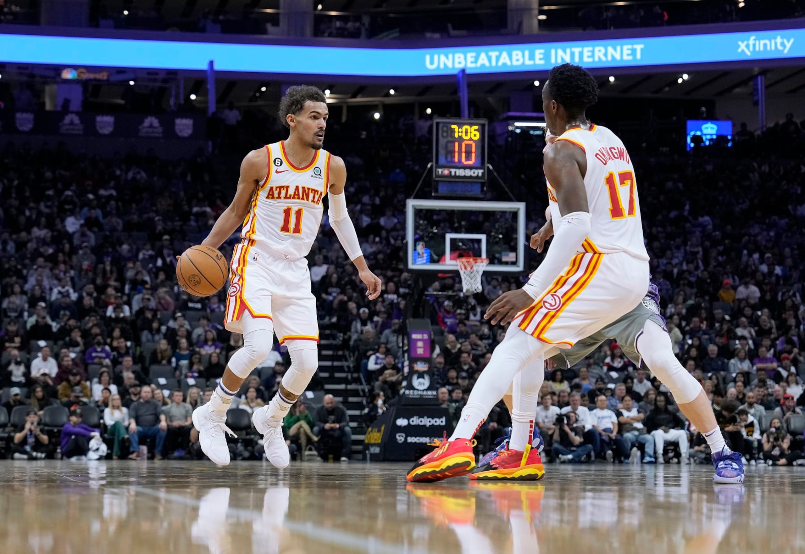 SACRAMENTO, CALIFORNIA - JANUARY 04: Trae Young #11 of the Atlanta Hawks dribbles the ball around a screen set by Onyeka Okongwu #17 on Kevin Huerter #9 of the Sacramento Kings during the third quarter of an NBA basketball game at Golden 1 Center on January 04, 2023 in Sacramento, California. NOTE TO USER: User expressly acknowledges and agrees that, by downloading and or using this photograph, User is consenting to the terms and conditions of the Getty Images License Agreement. (Photo by Thearon W. Henderson/Getty Images)