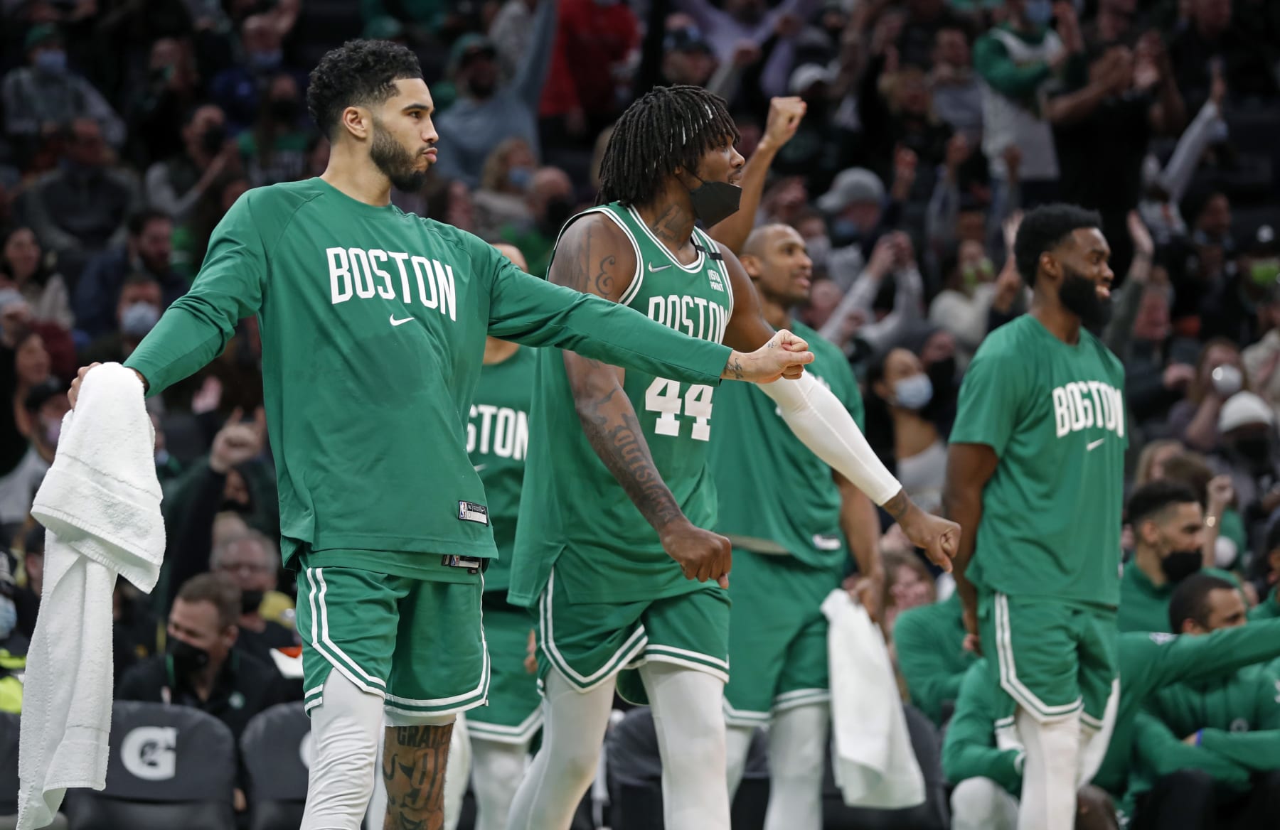Boston - January 25: In the fourth quarter as the Celtics lead by as many as 60 points, the starters were all on the bench, and here (left to right) Jayson Tatum, Robert Williams III, Al Horford and Jaylen Brown all celebrated a three pointer by teammate Payton Pritchard (not pictured). The Boston Celtics hosted the Sacramento Kings in a regular season NBA basketball game at the TD Garden in Boston on Jan. 25, 2022. (Photo by Jim Davis/The Boston Globe via Getty Images)