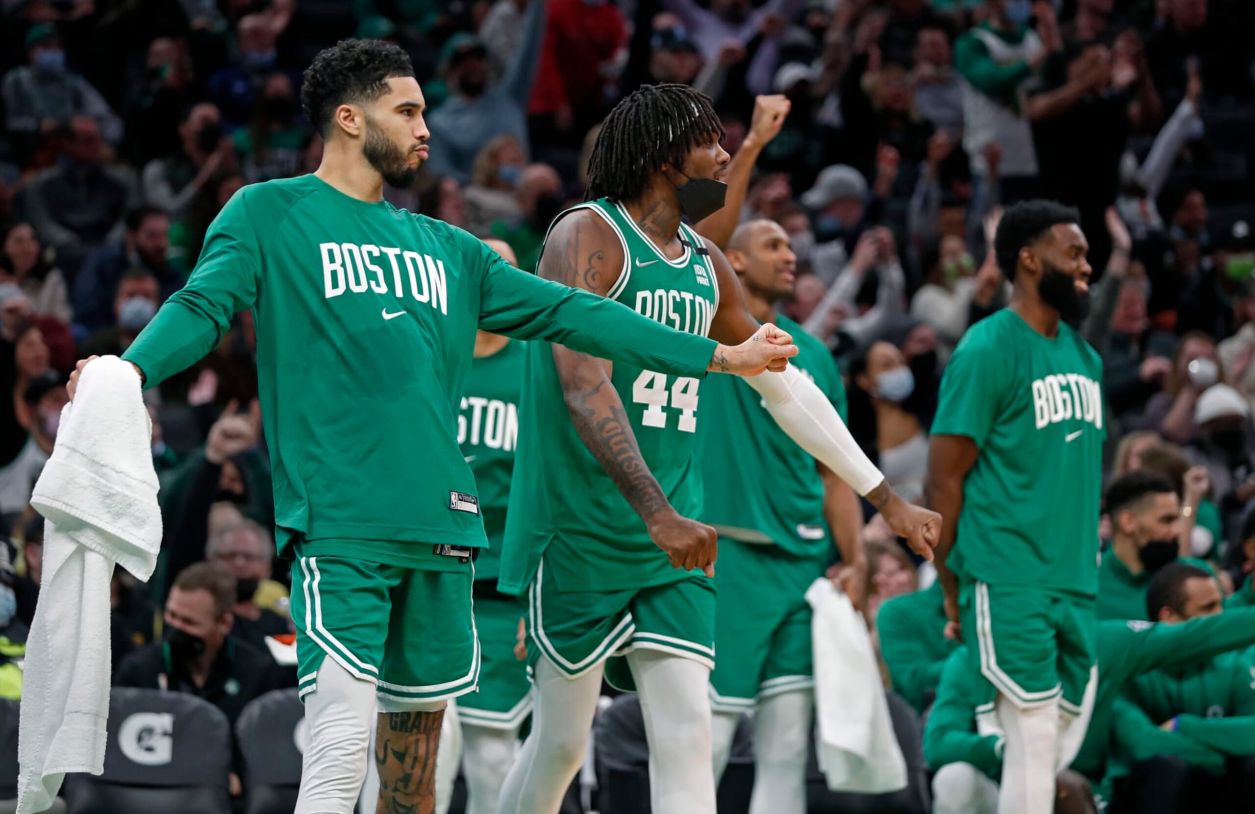 Boston - January 25: In the fourth quarter as the Celtics lead by as many as 60 points, the starters were all on the bench, and here (left to right) Jayson Tatum, Robert Williams III, Al Horford and Jaylen Brown all celebrated a three pointer by teammate Payton Pritchard (not pictured). The Boston Celtics hosted the Sacramento Kings in a regular season NBA basketball game at the TD Garden in Boston on Jan. 25, 2022. (Photo by Jim Davis/The Boston Globe via Getty Images)
