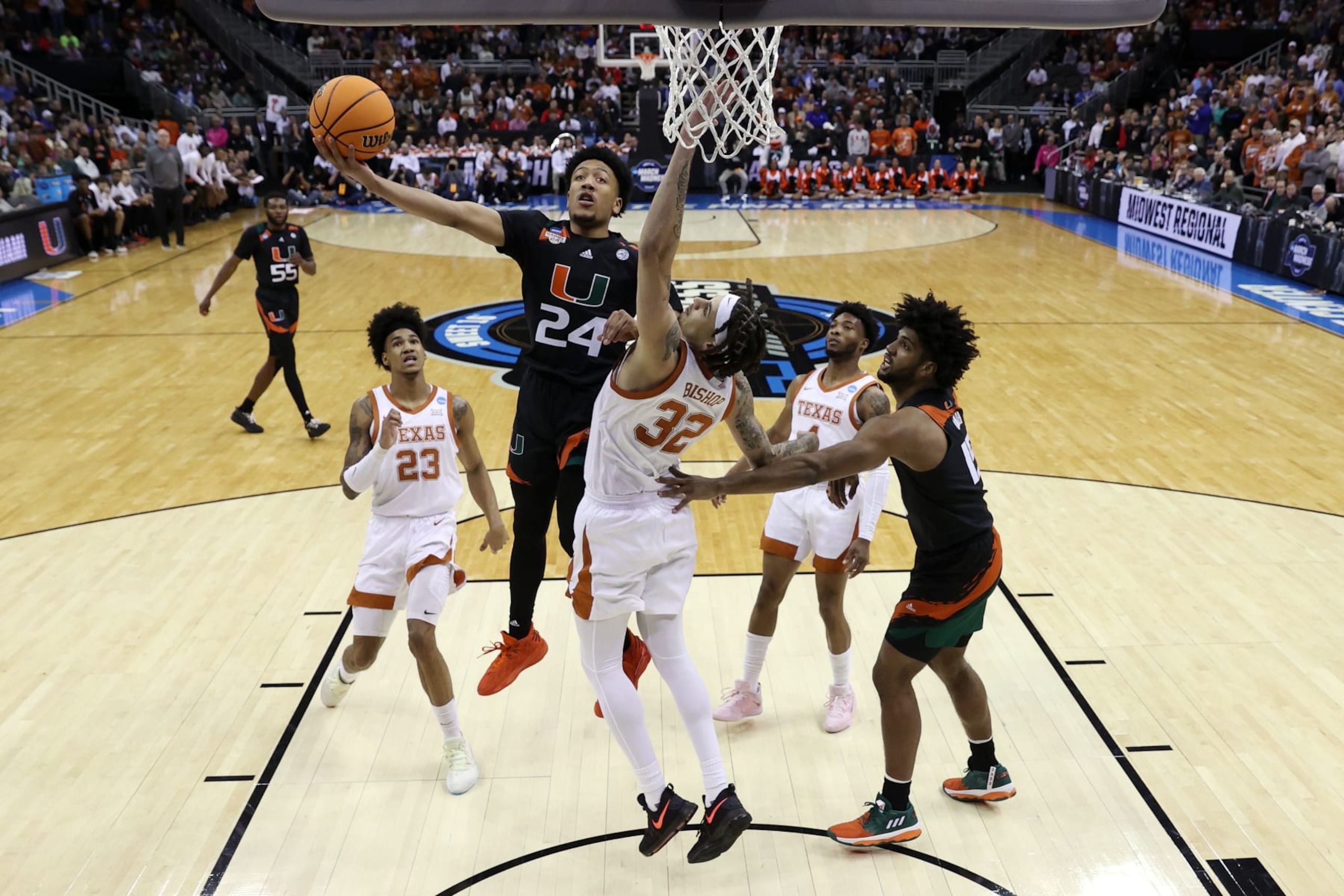 KANSAS CITY, MISSOURI - MARCH 26: Nijel Pack #24 of the Miami Hurricanes drives to the basket against Christian Bishop #32 of the Texas Longhorns during the first half in the Elite Eight round of the NCAA Men's Basketball Tournament at T-Mobile Center on March 26, 2023 in Kansas City, Missouri. (Photo by Jamie Squire/Getty Images)