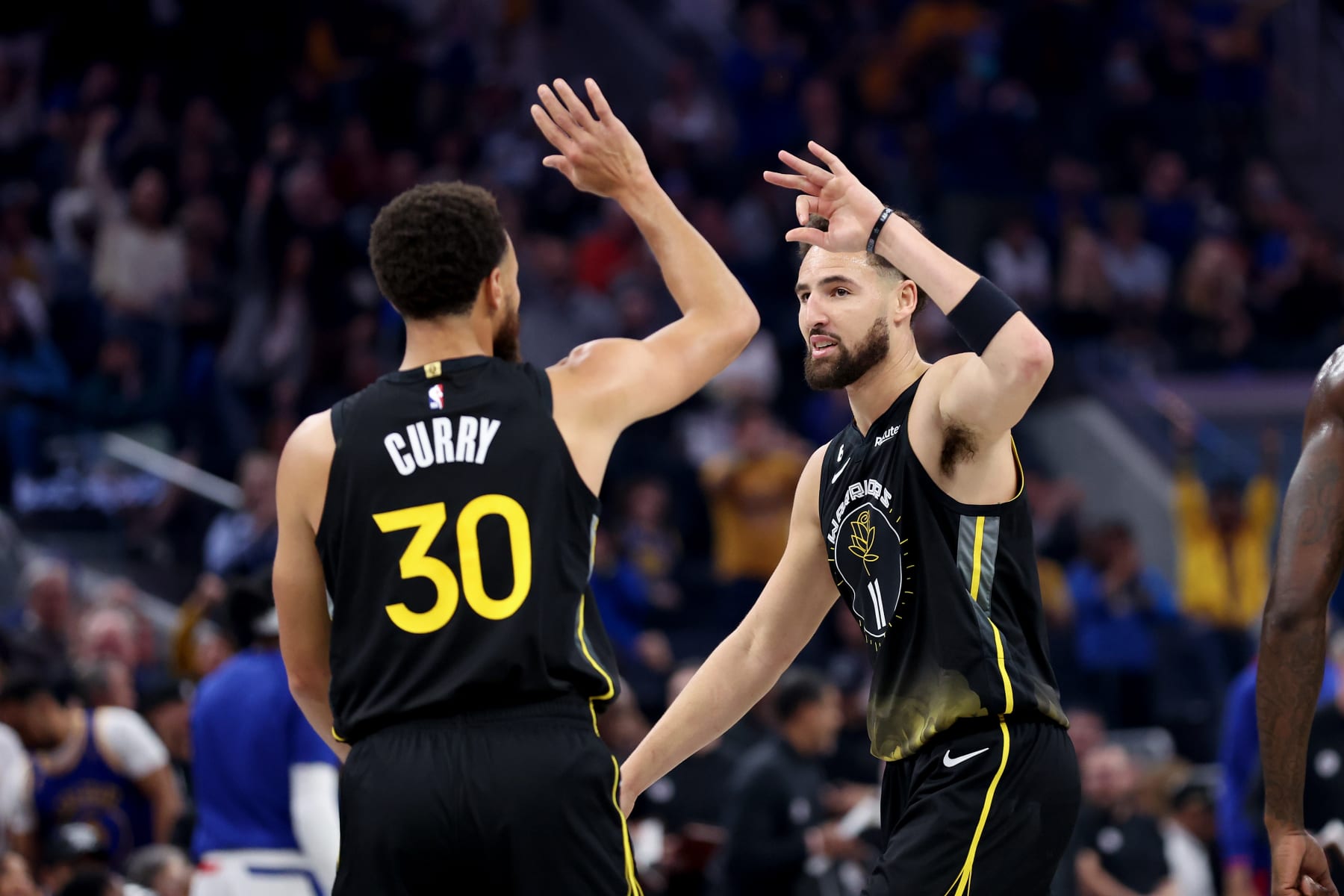 SAN FRANCISCO, CALIFORNIA - NOVEMBER 23: Stephen Curry #30 of the Golden State Warriors high-fives Klay Thompson #11 during their game against the LA Clippers at Chase Center on November 23, 2022 in San Francisco, California. NOTE TO USER: User expressly acknowledges and agrees that, by downloading and or using this photograph, User is consenting to the terms and conditions of the Getty Images License Agreement.  (Photo by Ezra Shaw/Getty Images)