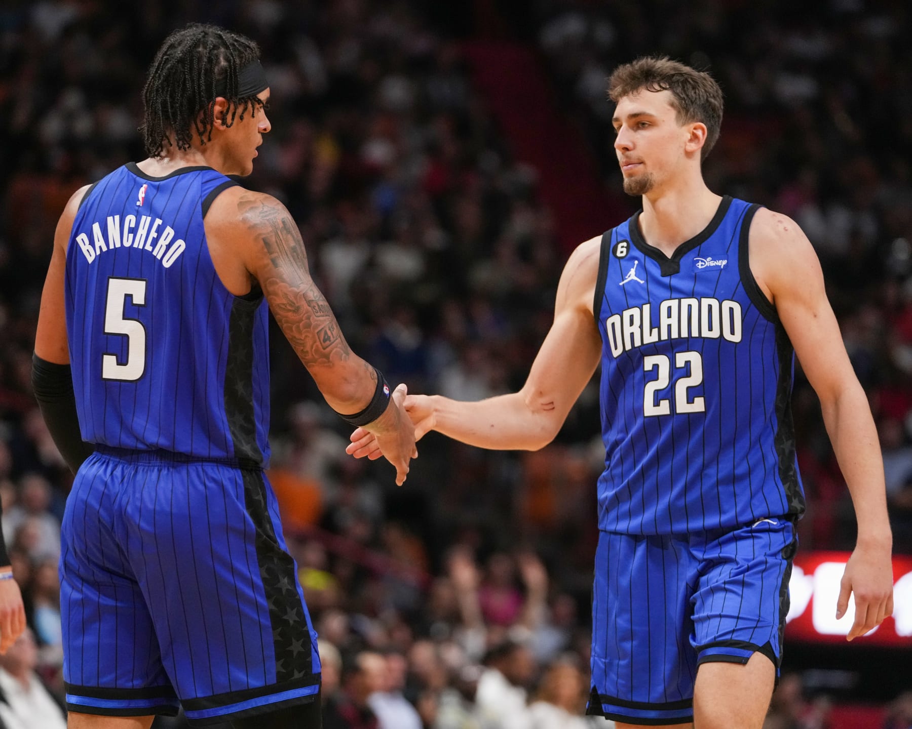 MIAMI, FL - JANUARY 27:  Paolo Banchero #5 and Franz Wagner #22 of the Orlando Magic shake hands during the game on January 27, 2023 at FTX Arena in Miami, Florida. NOTE TO USER: User expressly acknowledges and agrees that, by downloading and or using this Photograph, user is consenting to the terms and conditions of the Getty Images License Agreement. Mandatory Copyright Notice: Copyright 2023 NBAE (Photo by Eric Espada/NBAE via Getty Images)