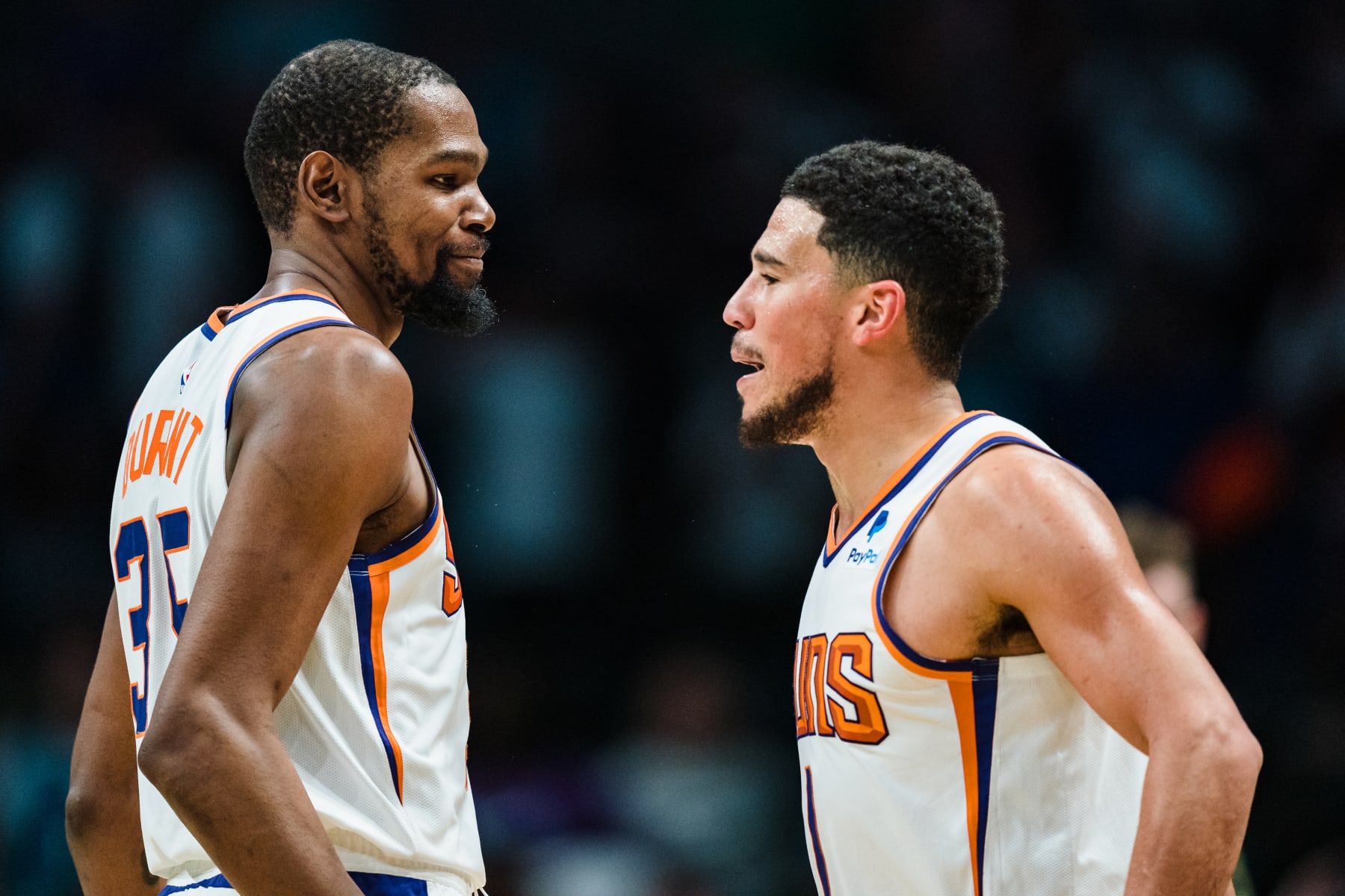 CHARLOTTE, NORTH CAROLINA - MARCH 01: Kevin Durant #35 celebrates with Devin Booker #1 of the Phoenix Suns in the fourth quarter during their game against the Charlotte Hornets at Spectrum Center on March 01, 2023 in Charlotte, North Carolina. NOTE TO USER: User expressly acknowledges and agrees that, by downloading and or using this photograph, User is consenting to the terms and conditions of the Getty Images License Agreement. (Photo by Jacob Kupferman/Getty Images)