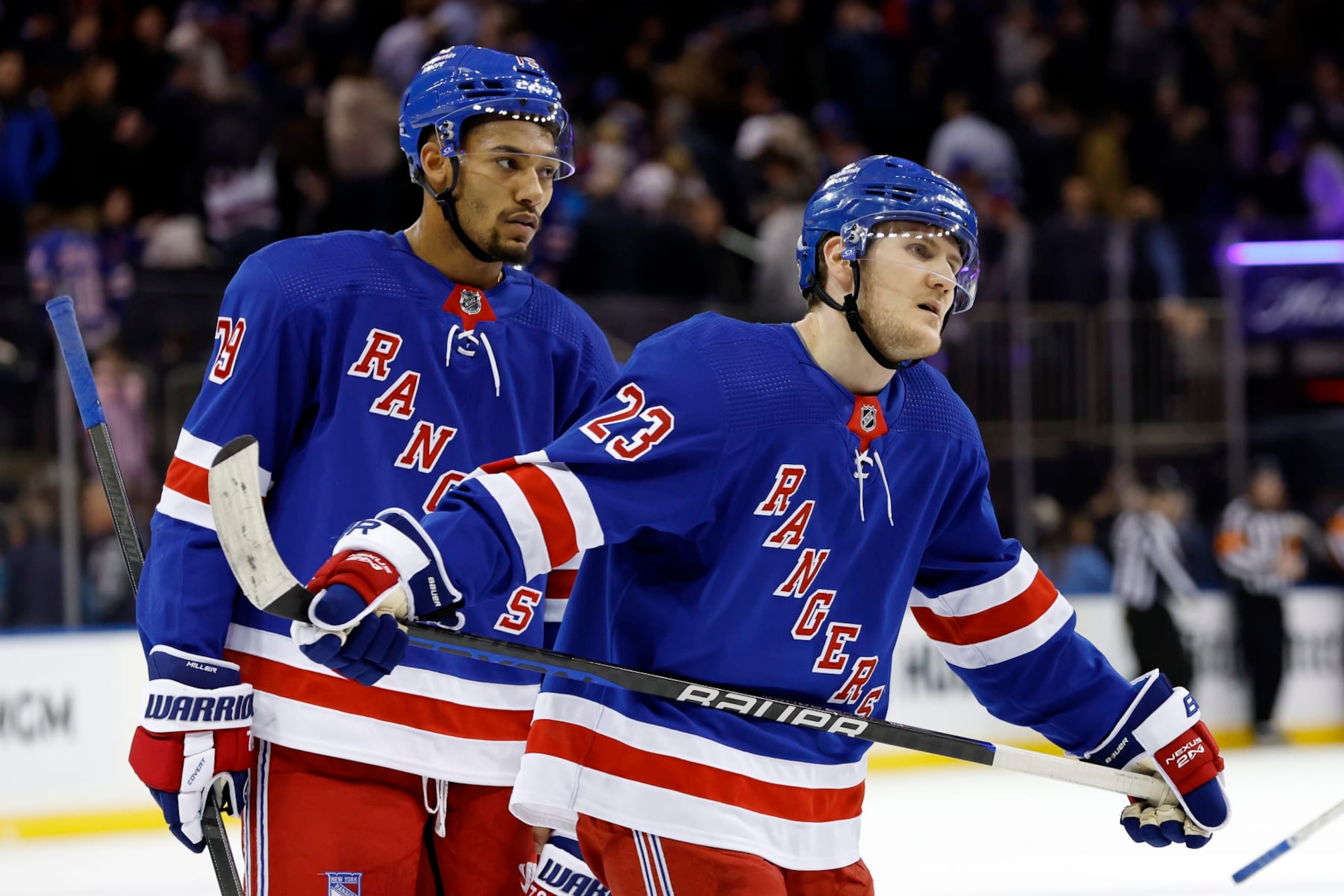NEW YORK, NEW YORK - MARCH 21: Adam Fox #23 and K'Andre Miller #79 of the New York Rangers react after the third period against the Carolina Hurricanes at Madison Square Garden on March 21, 2023 in New York City. The Hurricanes won 3-2. (Photo by Sarah Stier/Getty Images)