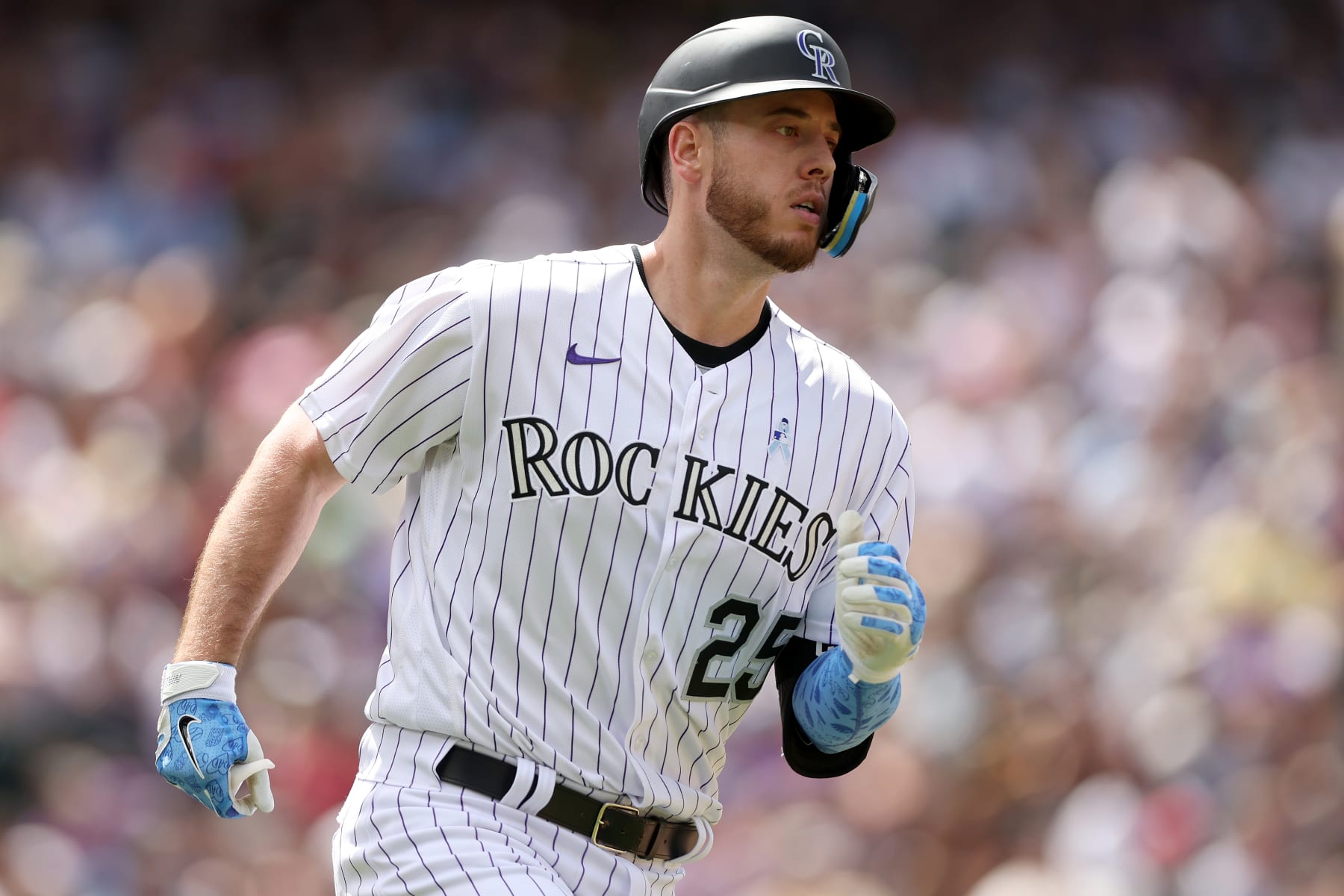 DENVER, COLORADO - JUNE 19: C.J. Cron #25 of the Colorado Rockies runs to first base after hitting a RBI single against the San Diego Padres in the fifth inning at Coors Field on June 19, 2022 in Denver, Colorado. (Photo by Matthew Stockman/Getty Images)