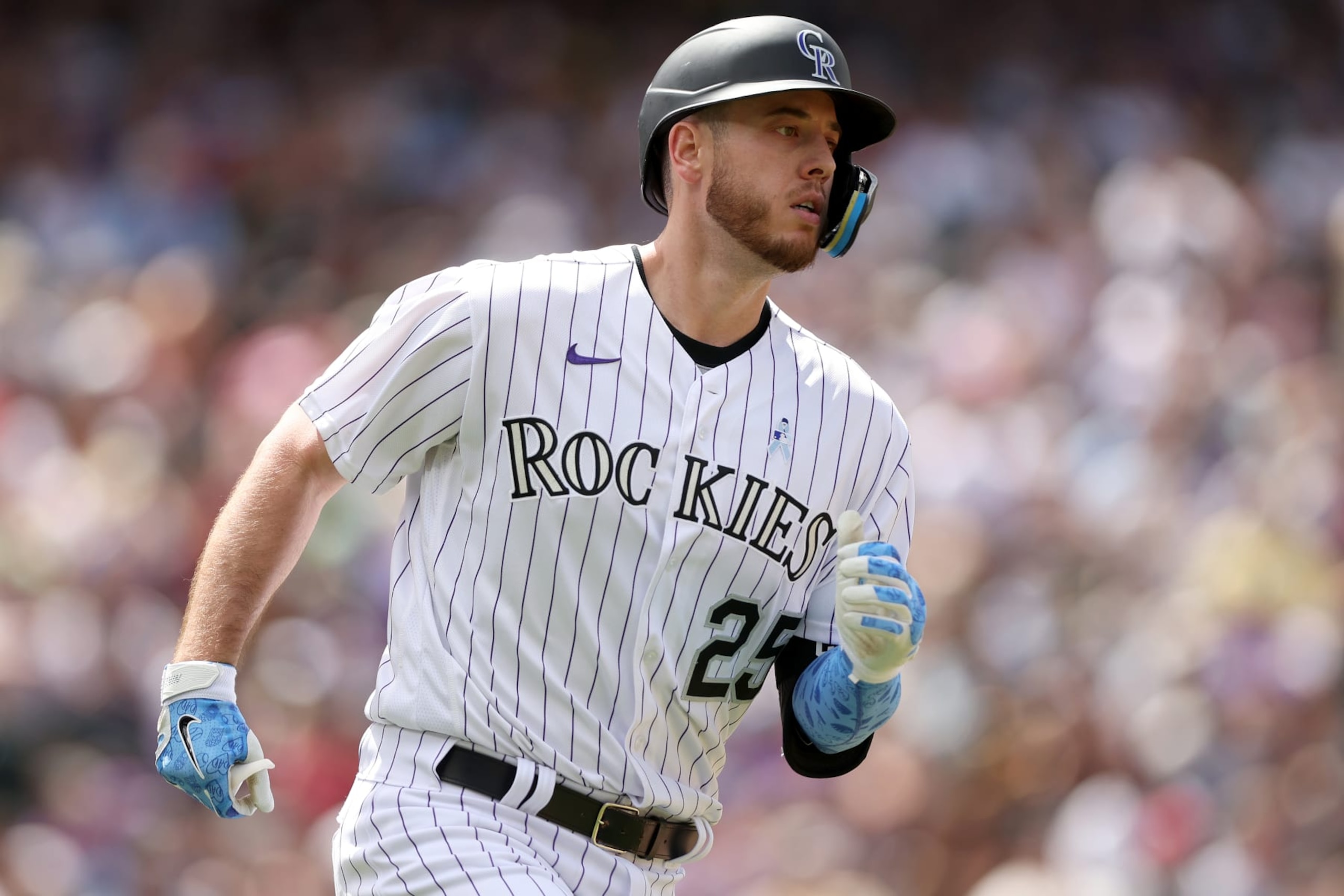 DENVER, COLORADO - JUNE 19: C.J. Cron #25 of the Colorado Rockies runs to first base after hitting a RBI single against the San Diego Padres in the fifth inning at Coors Field on June 19, 2022 in Denver, Colorado. (Photo by Matthew Stockman/Getty Images)