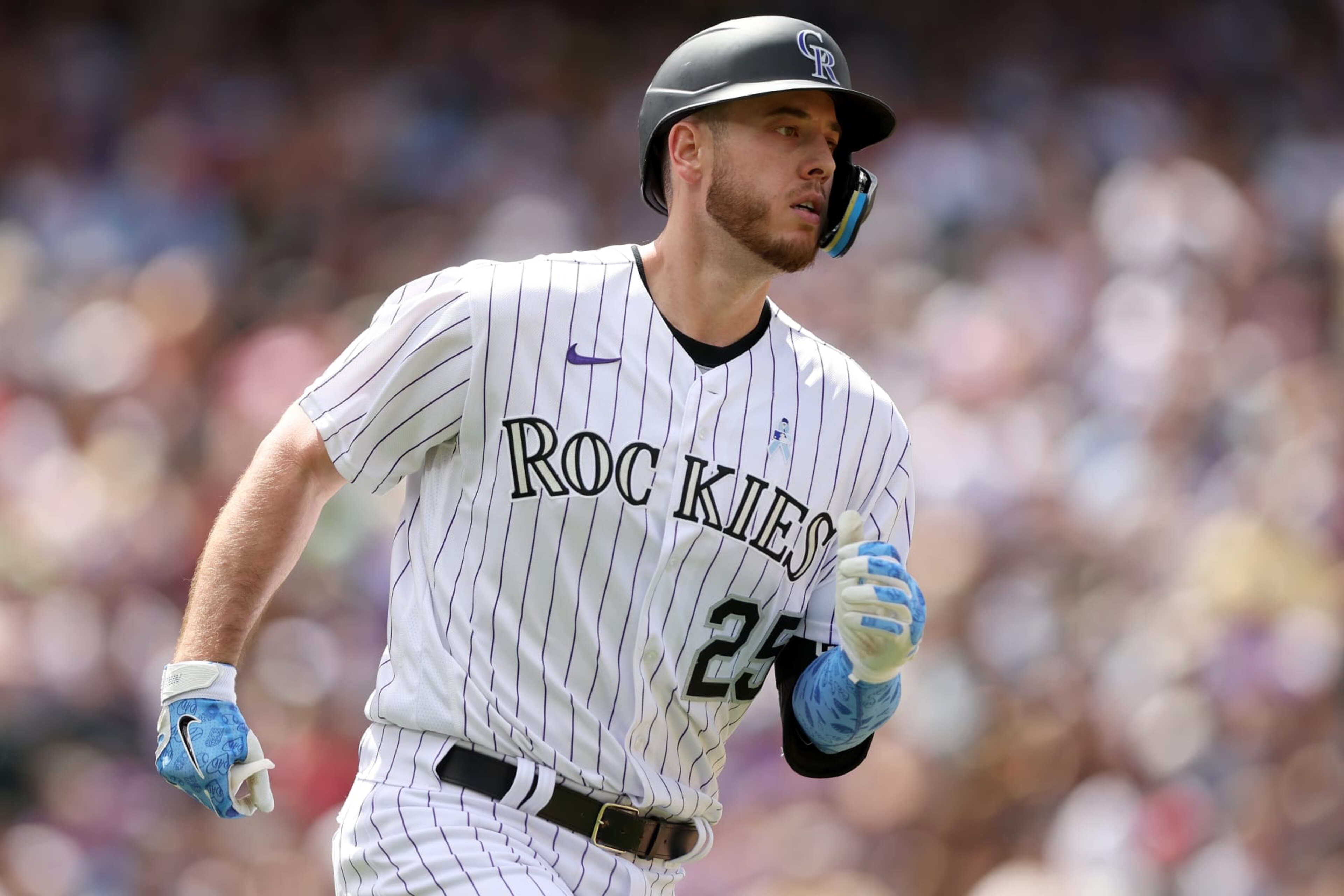 DENVER, COLORADO - JUNE 19: C.J. Cron #25 of the Colorado Rockies runs to first base after hitting a RBI single against the San Diego Padres in the fifth inning at Coors Field on June 19, 2022 in Denver, Colorado. (Photo by Matthew Stockman/Getty Images)