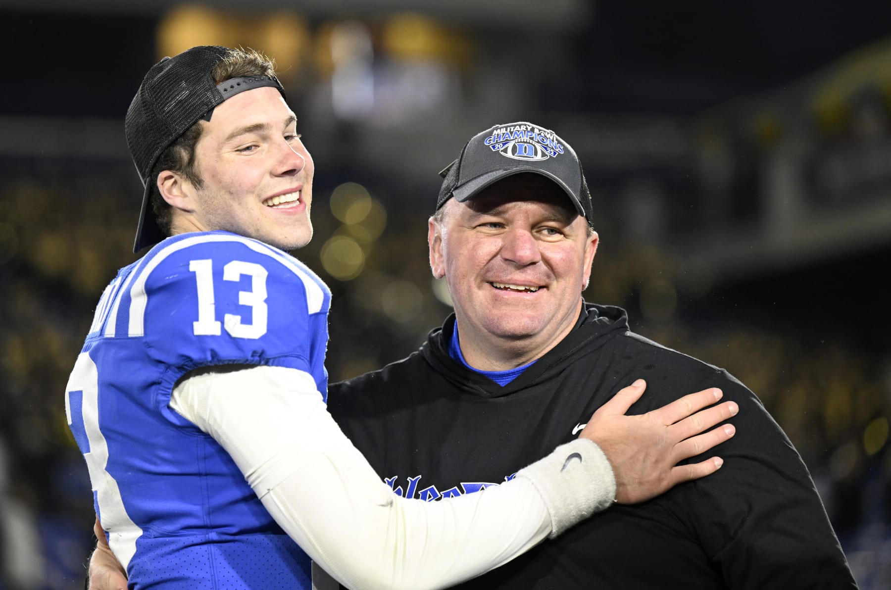ANNAPOLIS, MARYLAND - DECEMBER 28: Head coach Mike Elko of the Duke Blue Devils  celebrates with Riley Leonard #13 after a victory against the UCF Knights in the Military Bowl Presented by Peraton  at Navy-Marine Corps Memorial Stadium on December 28, 2022 in Annapolis, Maryland. (Photo by Greg Fiume/Getty Images)
