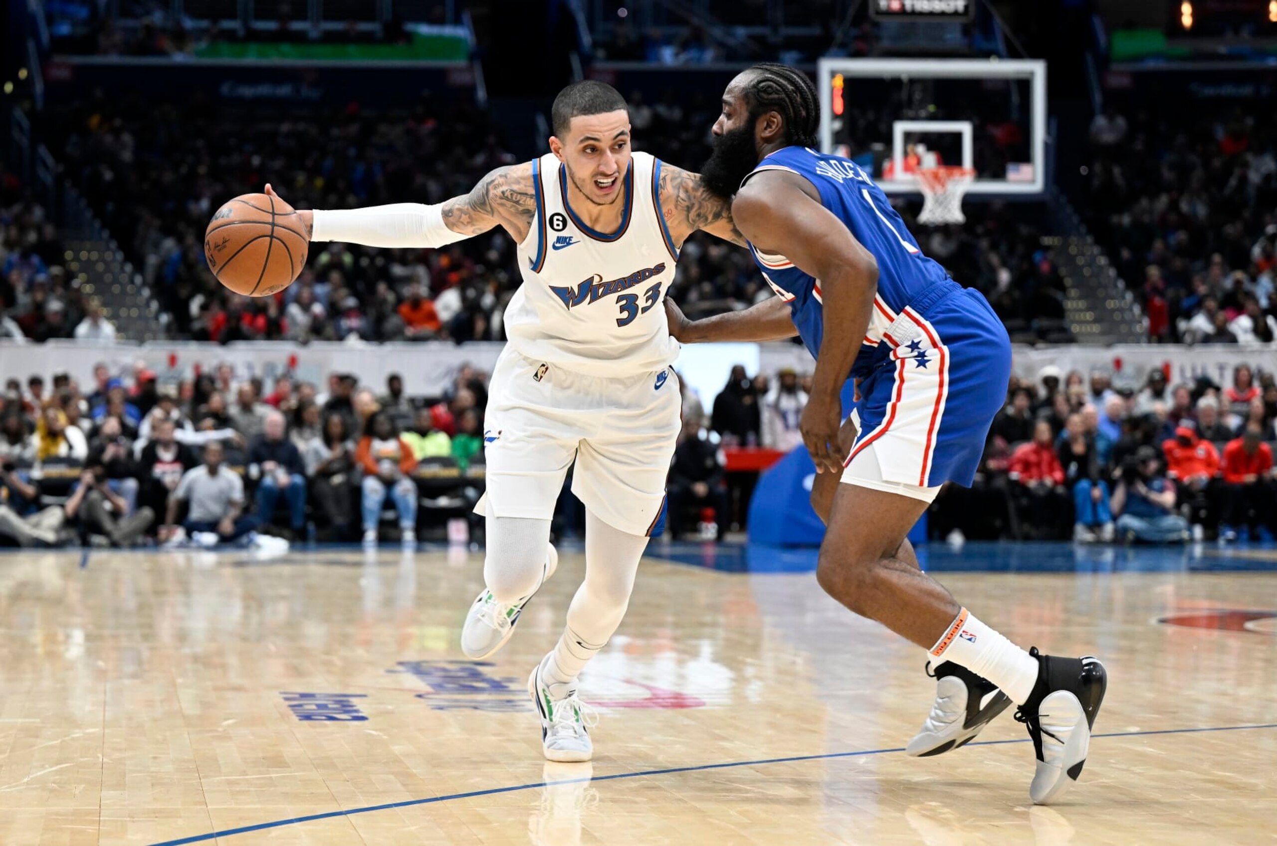 WASHINGTON, DC - DECEMBER 27: Kyle Kuzma #33 of the Washington Wizards handles the ball against James Harden #1 of the Philadelphia 76ers at Capital One Arena on December 27, 2022 in Washington, DC. NOTE TO USER: User expressly acknowledges and agrees that, by downloading and or using this photograph, User is consenting to the terms and conditions of the Getty Images License Agreement.  (Photo by G Fiume/Getty Images)