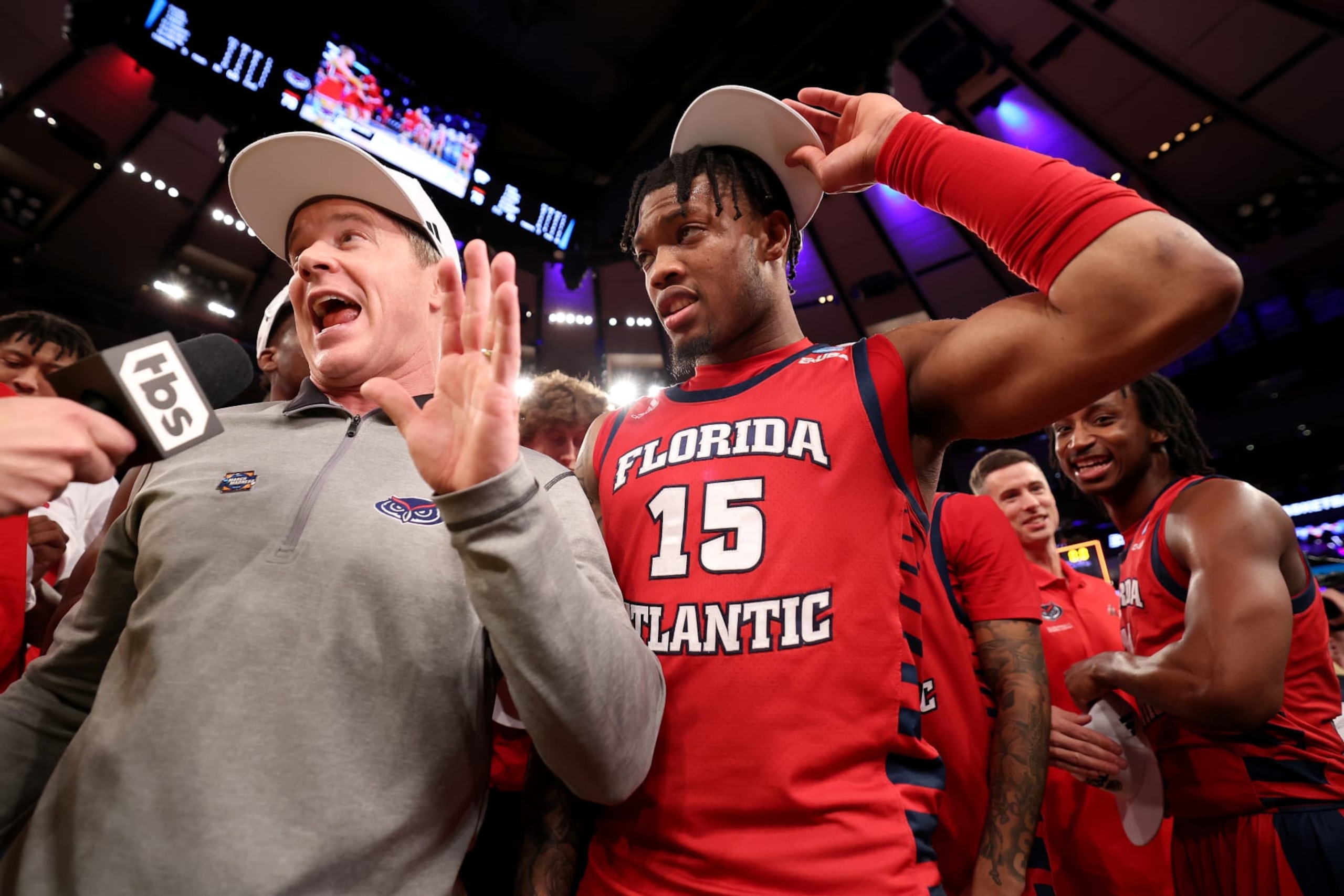 NEW YORK, NEW YORK - MARCH 25: Head coach Dusty May of the Florida Atlantic Owls talks to the media as Alijah Martin #15 looks on after defeating the Kansas State Wildcats in the Elite Eight round game of the NCAA Men's Basketball Tournament at Madison Square Garden on March 25, 2023 in New York City. (Photo by Al Bello/Getty Images)