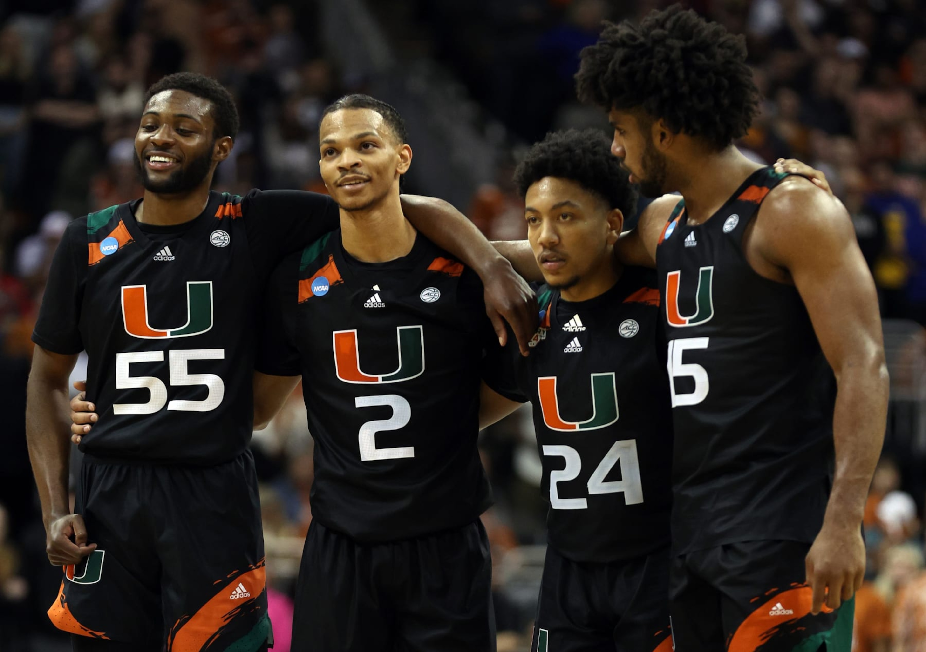 KANSAS CITY, MISSOURI - MARCH 26: (L-R) Wooga Poplar #55, Isaiah Wong #2, Nijel Pack #24 and Norchad Omier #15 of the Miami Hurricanes watch free throws during the second half against the Texas Longhorns in the Elite Eight round of the NCAA Men's Basketball Tournament at T-Mobile Center on March 26, 2023 in Kansas City, Missouri. (Photo by Jamie Squire/Getty Images)