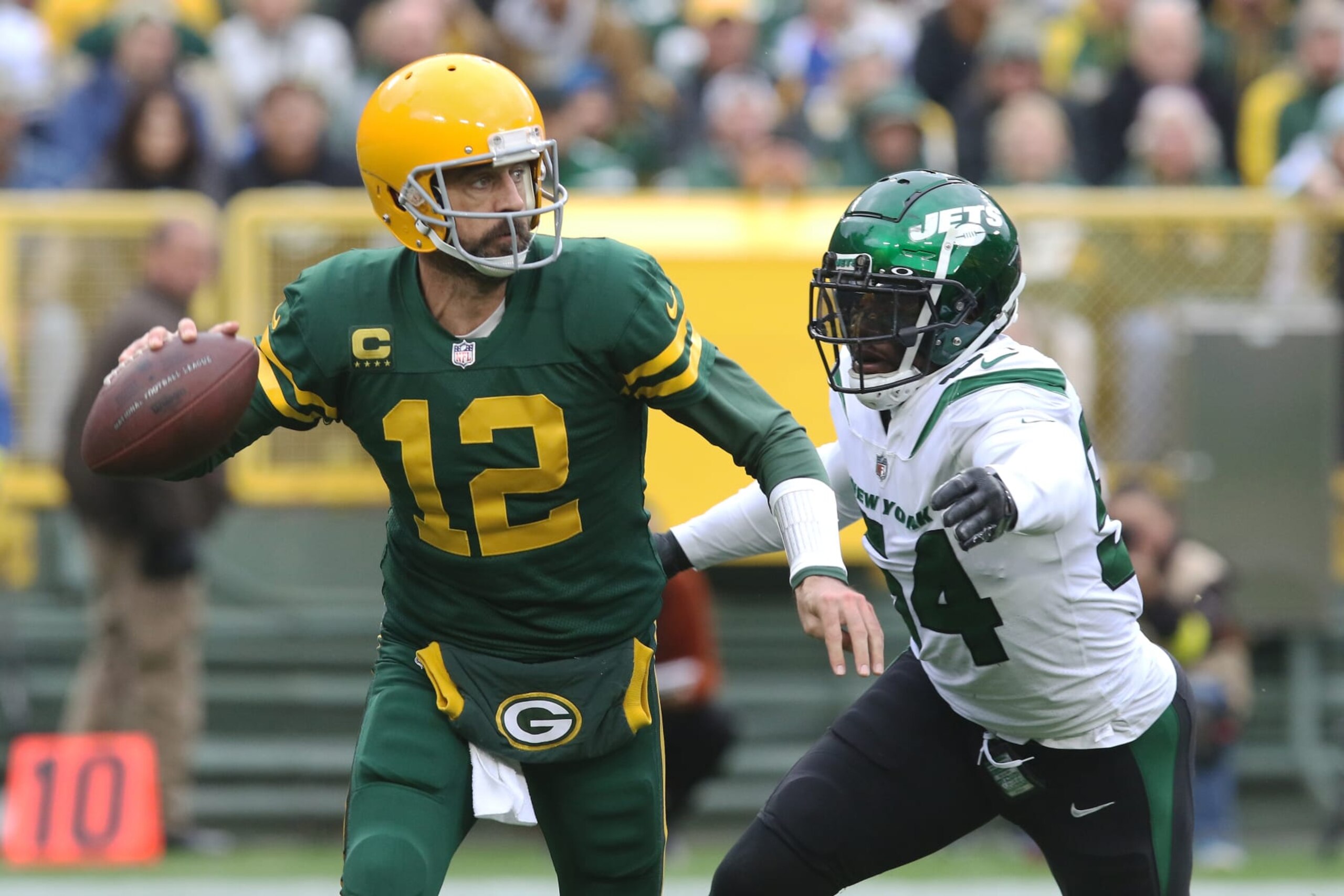 GREEN BAY, WI - OCTOBER 16: New York Jets defensive end Jacob Martin (54) chases down Green Bay Packers quarterback Aaron Rodgers (12) during a game between the Green Bay Packers and the New York Jets at Lambeau Field on October 16, 2022 in Green Bay, WI. (Photo by Larry Radloff/Icon Sportswire via Getty Images)