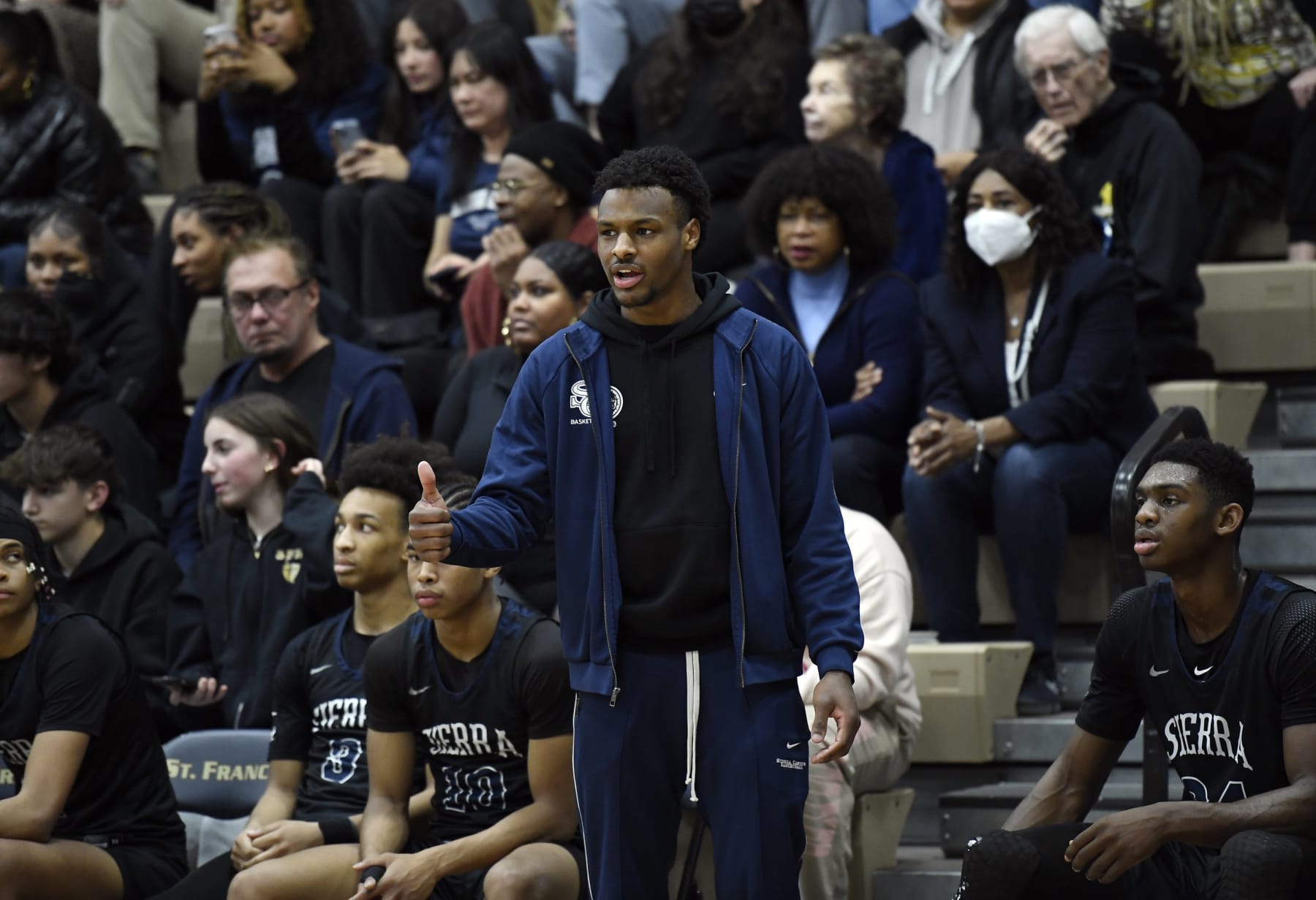 LA CANADA-FLINTRIDGE, CA - JANUARY 18: Bronny James #0 of Sierra Canyon High School, son of LeBron James of the NBA Los Angeles Lakers, cheers on  teammates from the bench during the second half against St. Francis High School on January 18, 2023 in La Canada-Flintridge, California. James did not play. (Photo by Kevork Djansezian/Getty Images)
