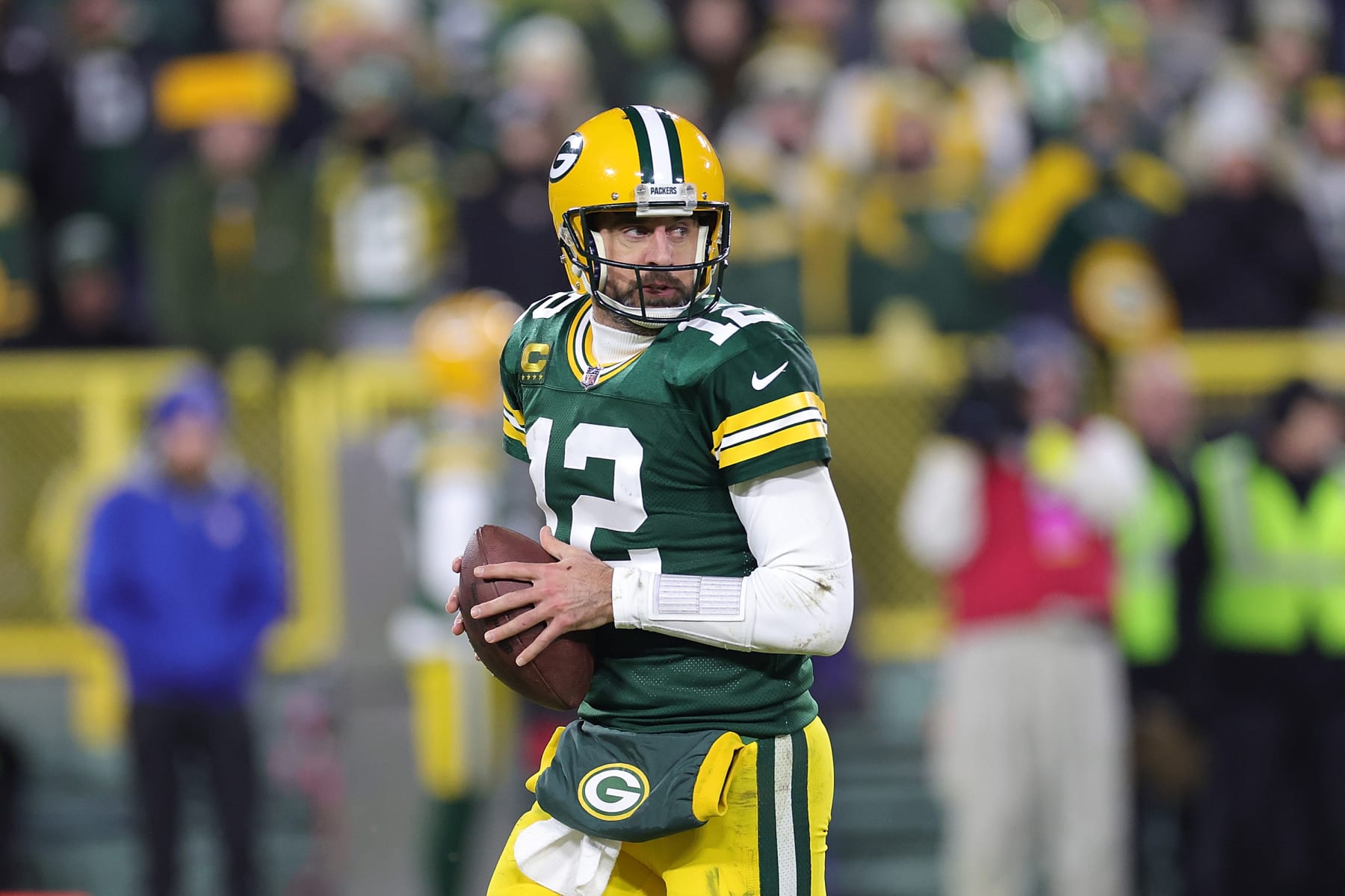 GREEN BAY, WISCONSIN - JANUARY 08: Aaron Rodgers #12 of the Green Bay Packers drops back to pass during a game against the Detroit Lions at Lambeau Field on January 08, 2023 in Green Bay, Wisconsin. The Lions defeated the Packers 20-16. (Photo by Stacy Revere/Getty Images)