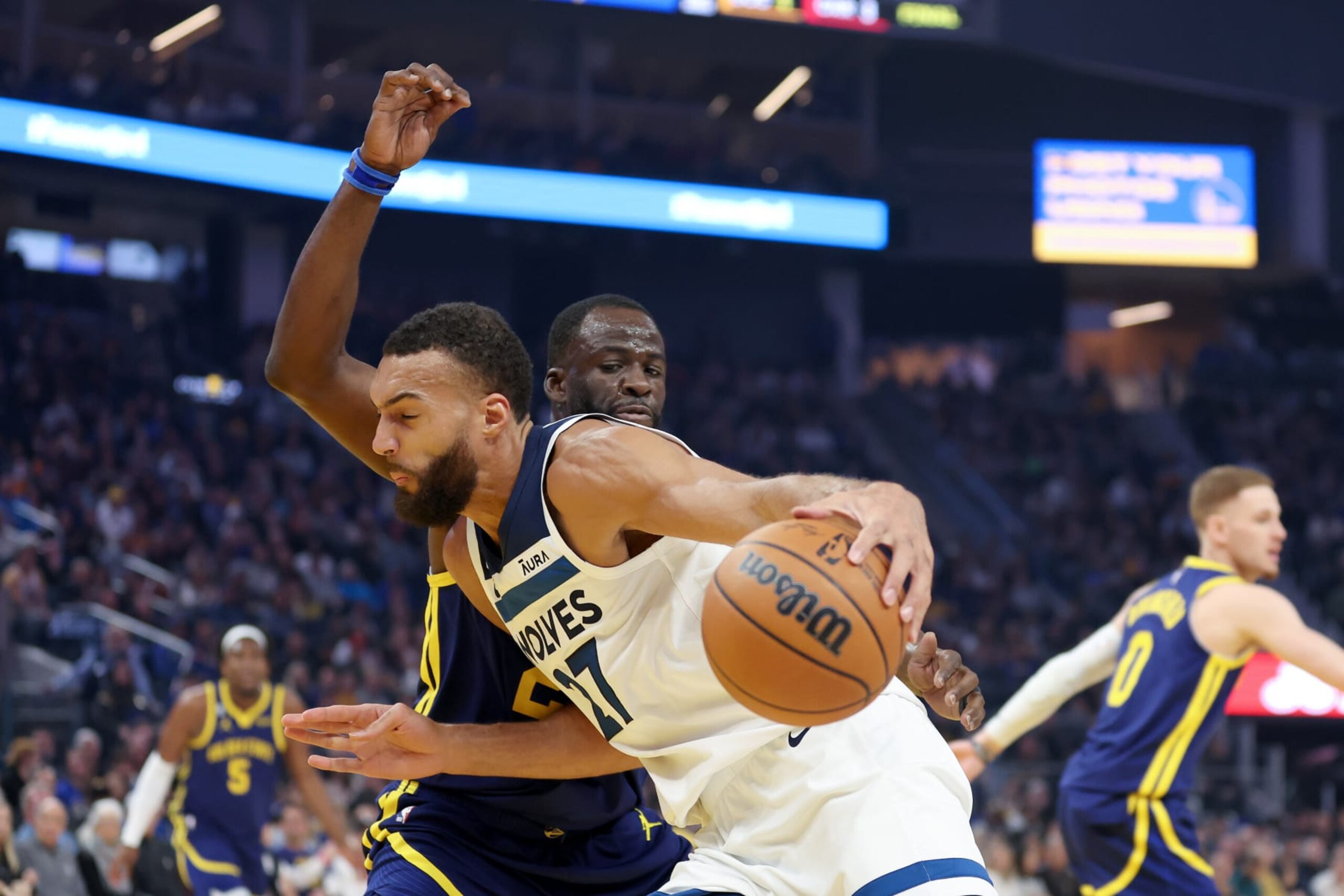 SAN FRANCISCO, CALIFORNIA - MARCH 26: Rudy Gobert #27 of the Minnesota Timberwolves is guarded by Draymond Green #23 of the Golden State Warriors in the first half at Chase Center on March 26, 2023 in San Francisco, California. NOTE TO USER: User expressly acknowledges and agrees that, by downloading and or using this photograph, User is consenting to the terms and conditions of the Getty Images License Agreement.  (Photo by Ezra Shaw/Getty Images)
