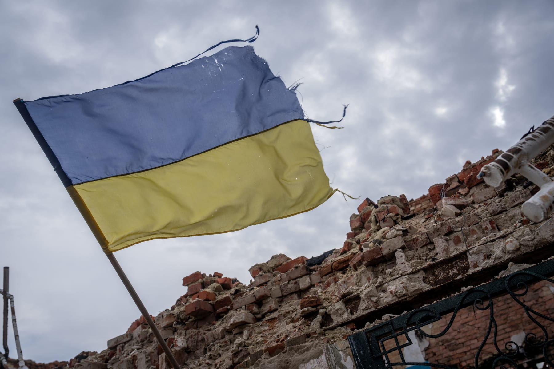 LUHANSK OBLAST, UKRAINE - MARCH 15: A Ukrainian flag on the wall of the destroyed school waves as Russian-Ukrainian war continues in Senkove village of Luhansk Oblast, Ukraine on March 15, 2023. (Photo by Wolfgang Schwan/Anadolu Agency via Getty Images)