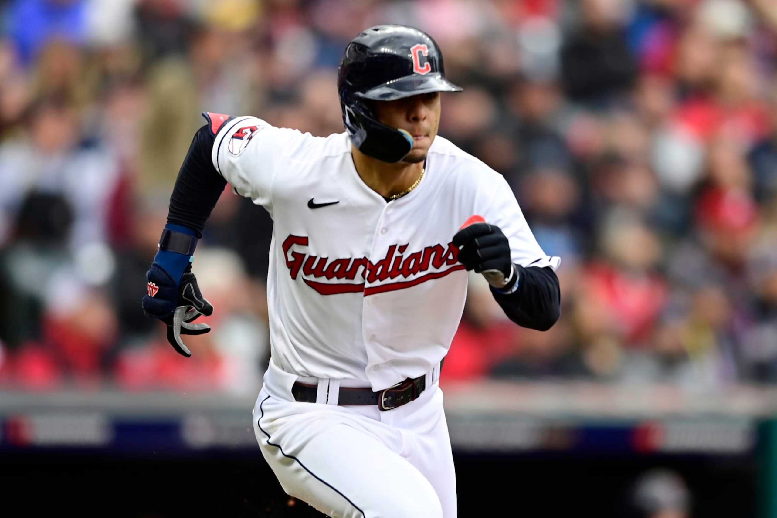 Cleveland Guardians' Andres Gimenez runs to first base with a single in the seventh inning of a wild card baseball playoff game against the Tampa Bay Rays, Friday, Oct. 7, 2022, in Cleveland. (AP Photo/David Dermer)