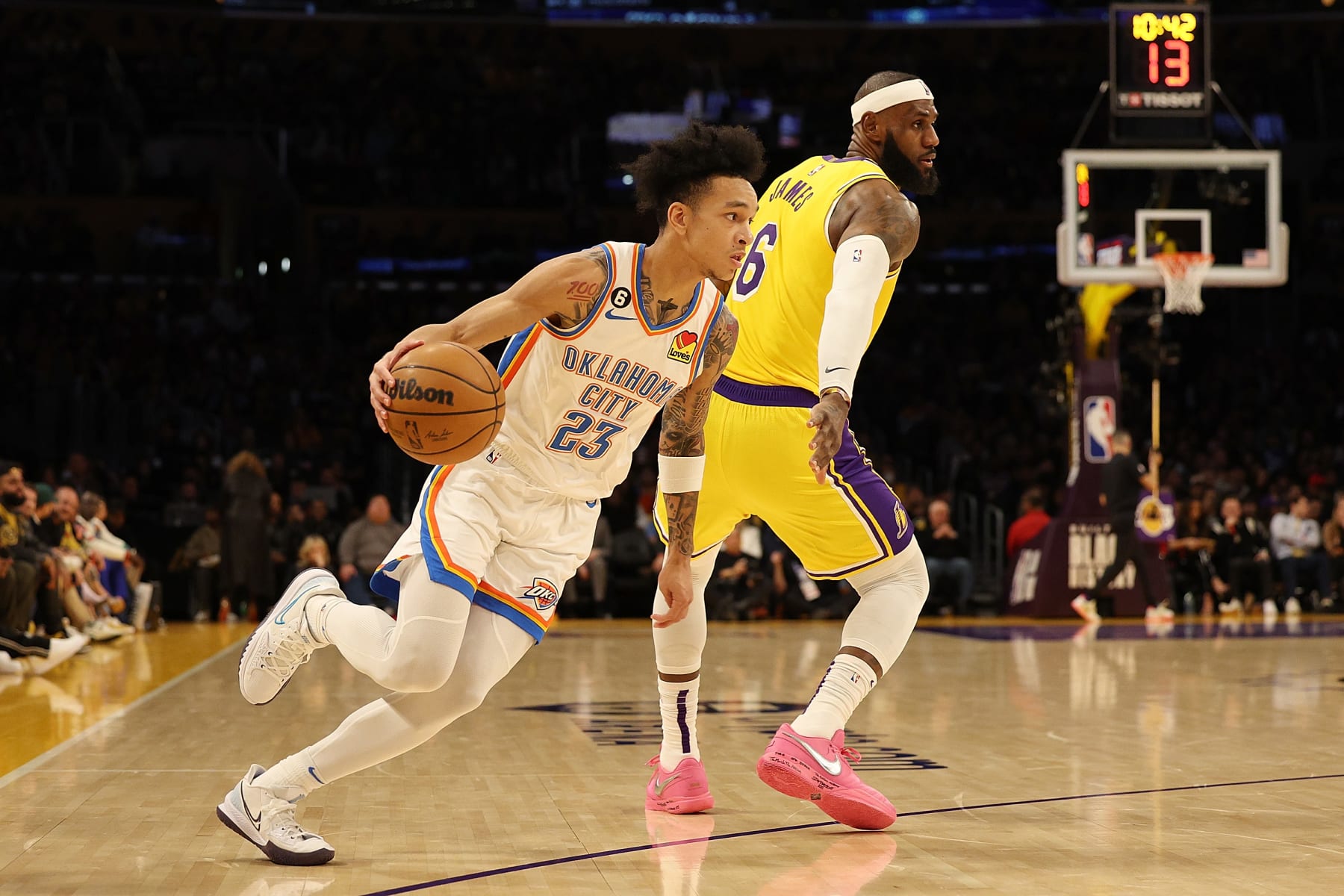 LOS ANGELES, CALIFORNIA - FEBRUARY 07: Tre Mann #23 of the Oklahoma City Thunder drives with the ball against LeBron James #6 of the Los Angeles Lakers in the second quarter at Crypto.com Arena on February 07, 2023 in Los Angeles, California. NOTE TO USER: User expressly acknowledges and agrees that, by downloading and or using this photograph, User is consenting to the terms and conditions of the Getty Images License Agreement. (Photo by Harry How/Getty Images)