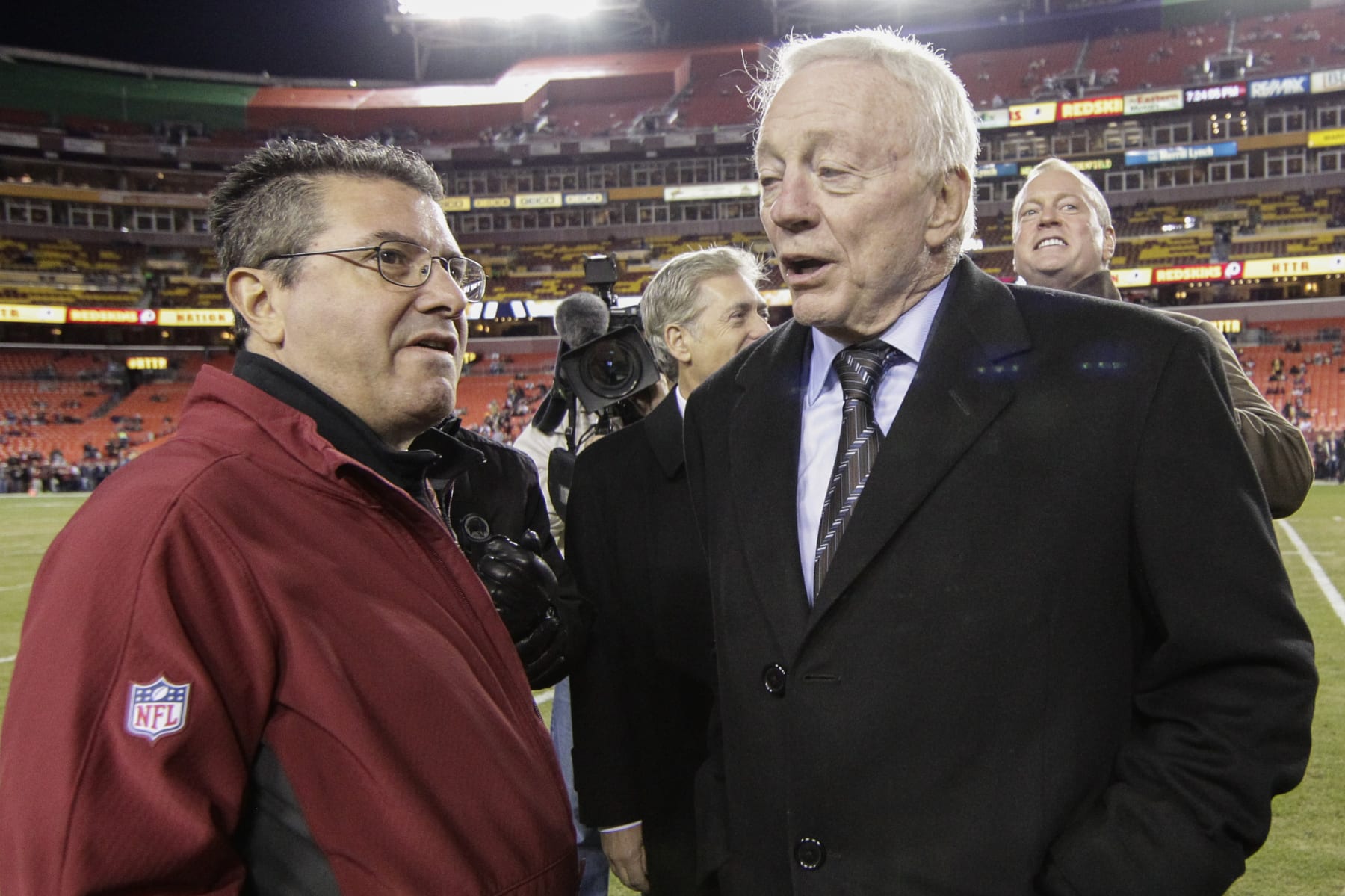 Washington Redskins owner Daniel Snyder talks with Dallas Cowboys owner Jerry Jones, right, before an NFL football game between the Redskins and the Cowboys in Landover, Md., Monday, Dec. 7, 2015. (AP Photo/Mark Tenally)