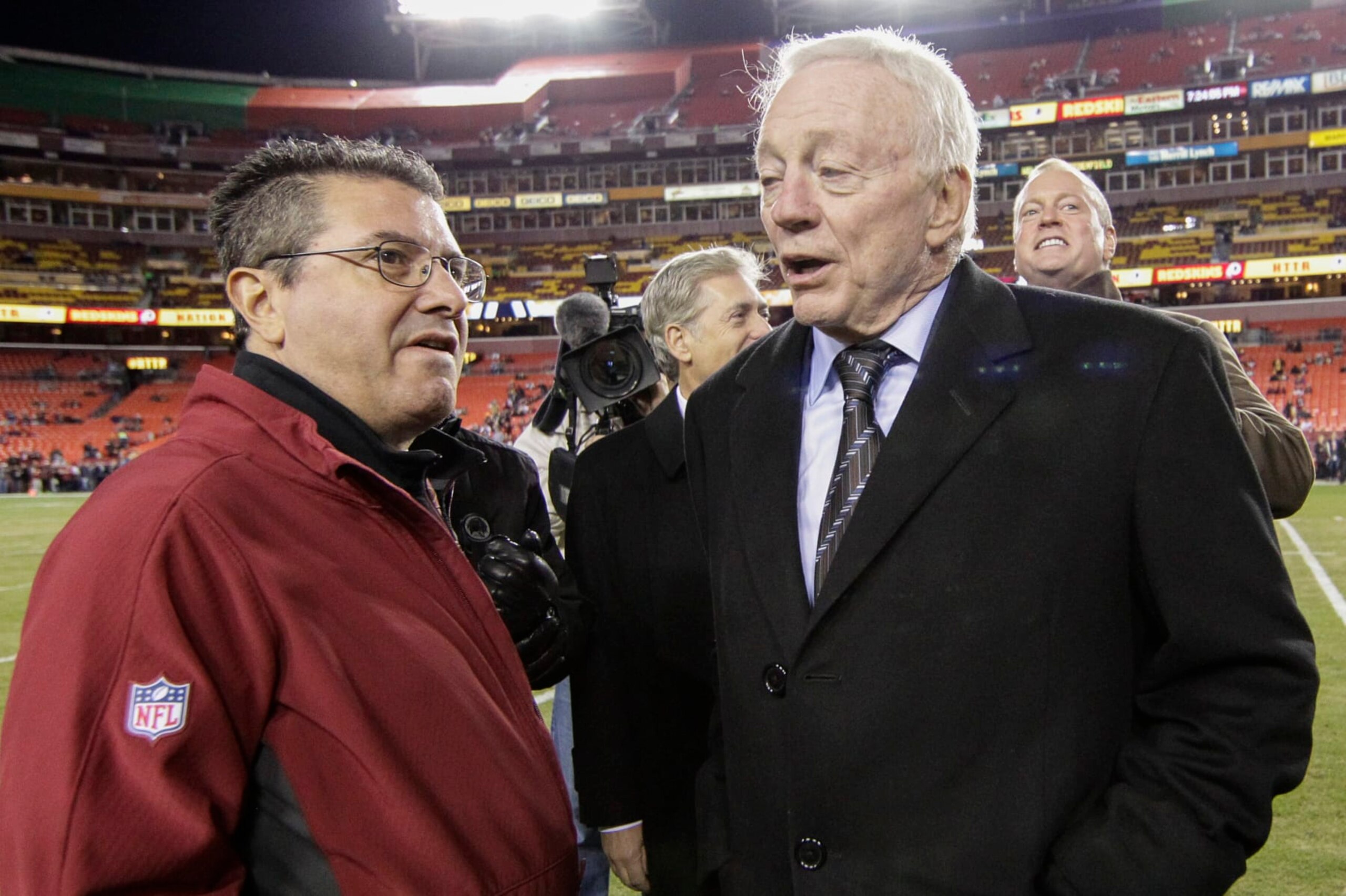 Washington Redskins owner Daniel Snyder talks with Dallas Cowboys owner Jerry Jones, right, before an NFL football game between the Redskins and the Cowboys in Landover, Md., Monday, Dec. 7, 2015. (AP Photo/Mark Tenally)
