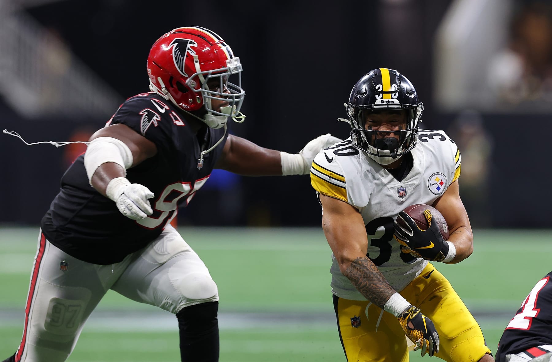 ATLANTA, GEORGIA - DECEMBER 04:  Jaylen Warren #30 of the Pittsburgh Steelers against Grady Jarrett #97 of the Atlanta Falcons at Mercedes-Benz Stadium on December 04, 2022 in Atlanta, Georgia. (Photo by Kevin C. Cox/Getty Images)