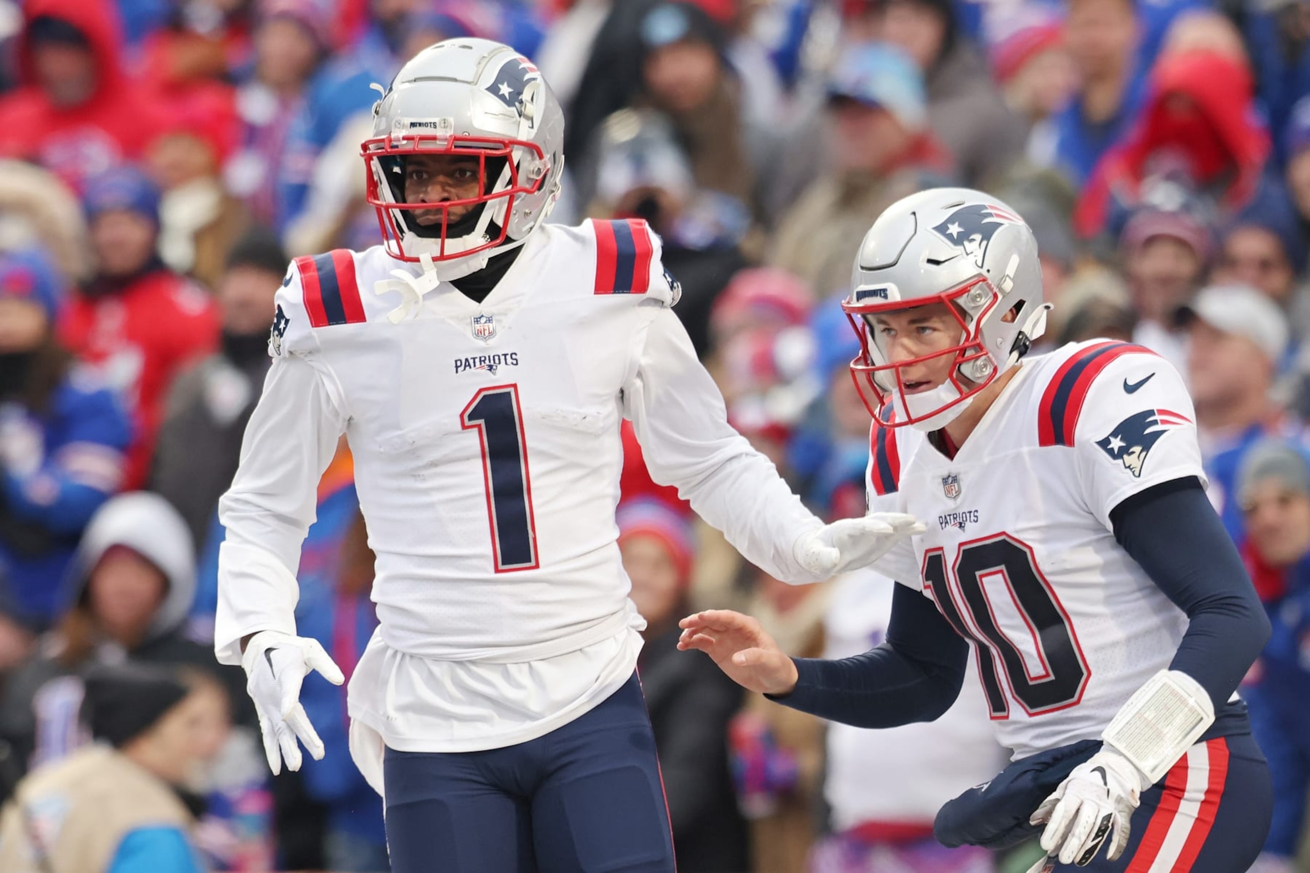 ORCHARD PARK, NEW YORK - JANUARY 08: DeVante Parker #1 of the New England Patriots and Mac Jones #10 of the New England Patriots celebrate after Parker's touchdown reception during the fourth quarter against the Buffalo Bills at Highmark Stadium on January 08, 2023 in Orchard Park, New York. (Photo by Bryan M. Bennett/Getty Images)