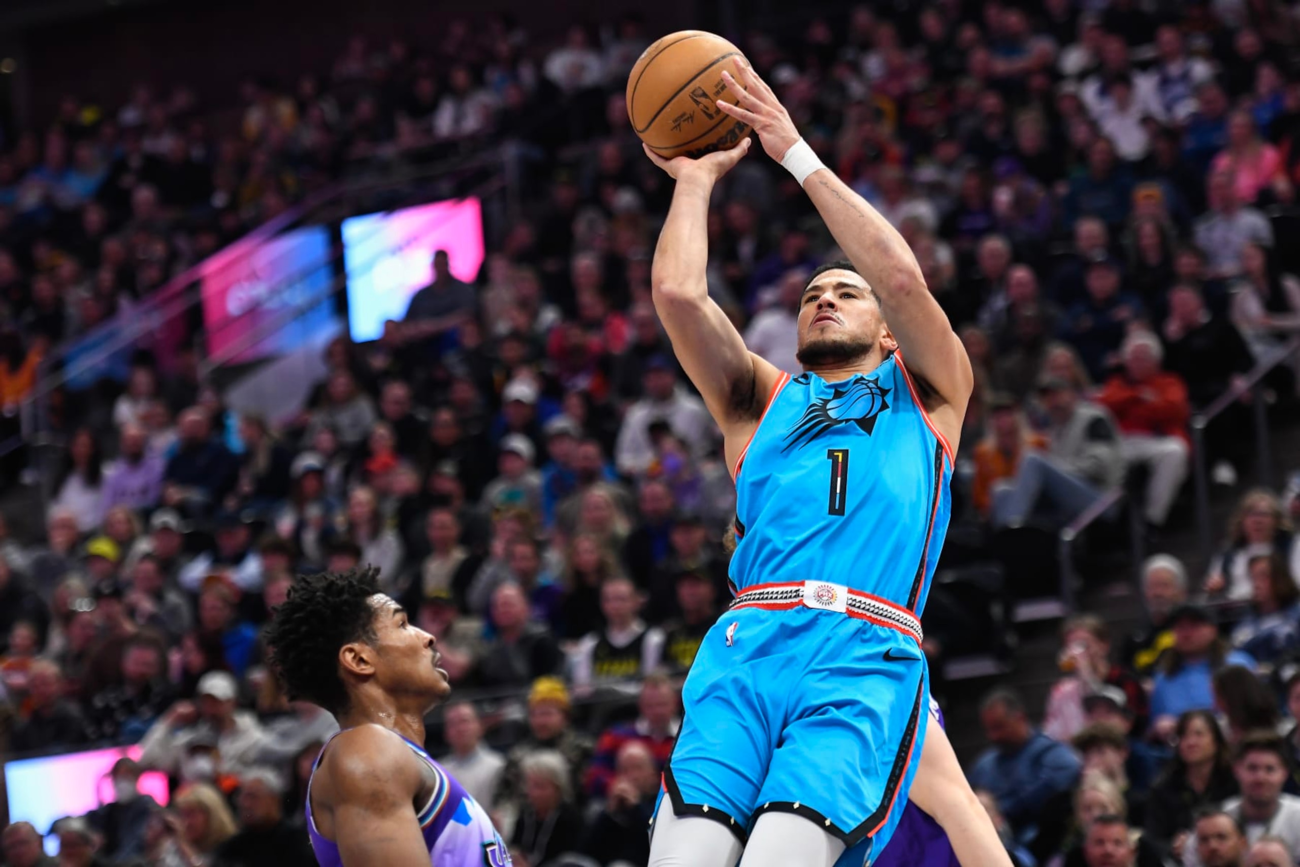 SALT LAKE CITY, UTAH - MARCH 27: Devin Booker #1 of the Phoenix Suns shoots over Ochai Agbaji #30 of the Utah Jazz during the first half at Vivint Arena on March 27, 2023 in Salt Lake City, Utah. NOTE TO USER: User expressly acknowledges and agrees that, by downloading and or using this photograph, User is consenting to the terms and conditions of the Getty Images License Agreement. (Photo by Alex Goodlett/Getty Images)