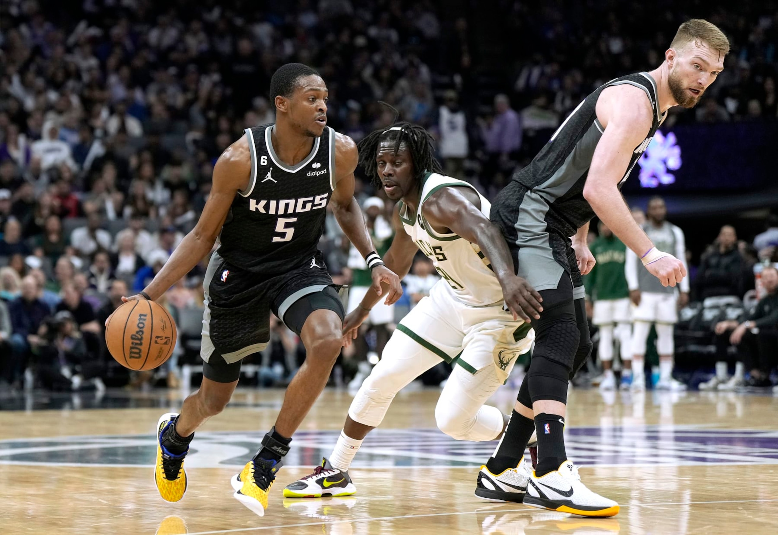 SACRAMENTO, CALIFORNIA - MARCH 13: De'Aaron Fox #5 of the Sacramento Kings dribbles around a screen set by Domantas Sabonis #10 on Jrue Holiday #21 of the Milwaukee Bucks during the fourth quarter of an NBA basketball game at Golden 1 Center on March 13, 2023 in Sacramento, California. NOTE TO USER: User expressly acknowledges and agrees that, by downloading and or using this photograph, User is consenting to the terms and conditions of the Getty Images License Agreement. (Photo by Thearon W. Henderson/Getty Images) SACRAMENTO, CALIFORNIA - MARCH 13: De'Aaron Fox #5 of the Sacramento Kings dribbles around a screen set by Domantas Sabonis #10 on Jrue Holiday #21 of the Milwaukee Bucks during the fourth quarter of an NBA basketball game at Golden 1 Center on March 13, 2023 in Sacramento, California. NOTE TO USER: User expressly acknowledges and agrees that, by downloading and or using this photograph, User is consenting to the terms and conditions of the Getty Images License Agreement. (Photo by Thearon W. Henderson/Getty Images)