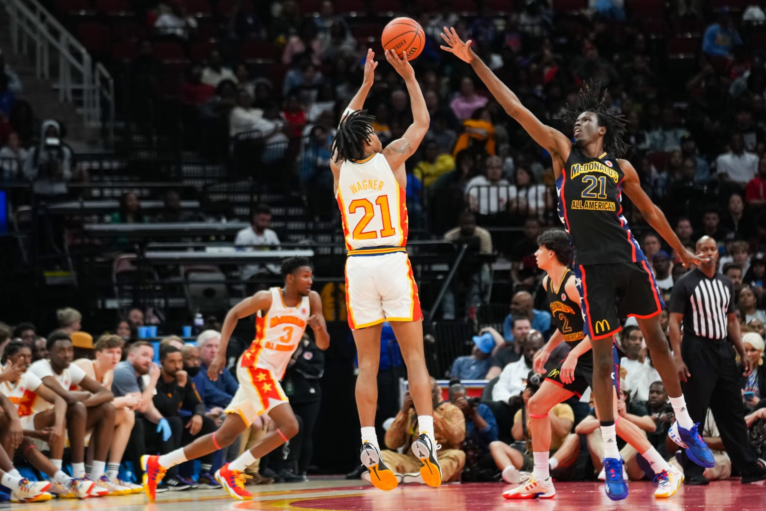 HOUSTON, TEXAS - MARCH 28: DJ Wagner #21of the East team attempts a three point shot over Baye Fall #21 of the West team in the 2023 McDonald's High School All-American Game at Toyota Center on March 28, 2023 in Houston, Texas. (Photo by Alex Bierens de Haan/Getty Images)