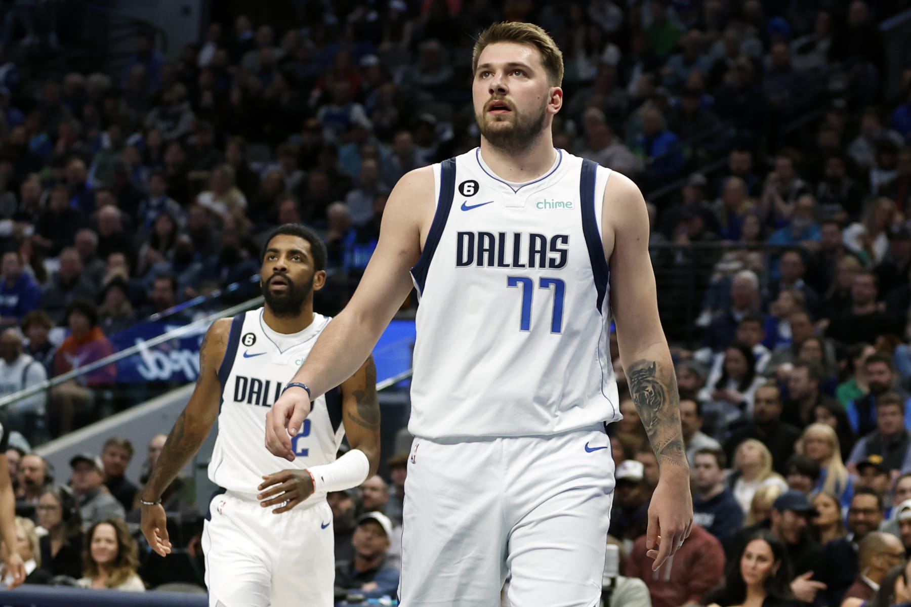 DALLAS, TEXAS - FEBRUARY 23: Luka Doncic #77 and Kyrie Irving #2 of the Dallas Mavericks watch a shot in the first half against the San Antonio Spurs at American Airlines Center on February 23, 2023 in Dallas, Texas. NOTE TO USER: User expressly acknowledges and agrees that, by downloading and or using this photograph, User is consenting to the terms and conditions of the Getty Images License Agreement. (Photo by Tim Heitman/Getty Images) (Photo by Tim Heitman/Getty Images) (Photo by Tim Heitman/Getty Images)