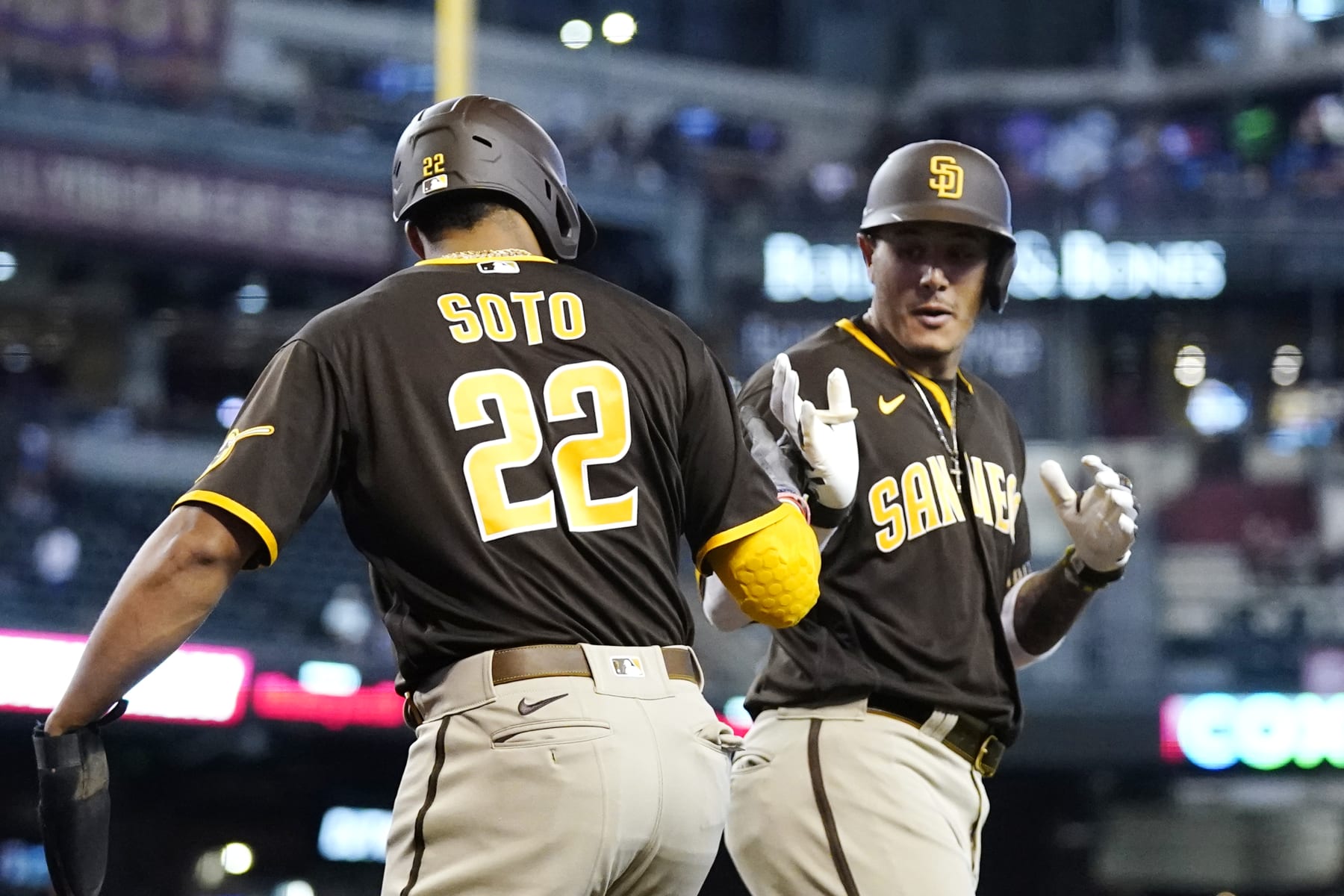 San Diego Padres' Manny Machado, right, celebrates his two-run home run against the Arizona Diamondbacks with Padres' Juan Soto (22) during the first inning of a baseball game in Phoenix, Sunday, Sept. 18, 2022. (AP Photo/Ross D. Franklin)