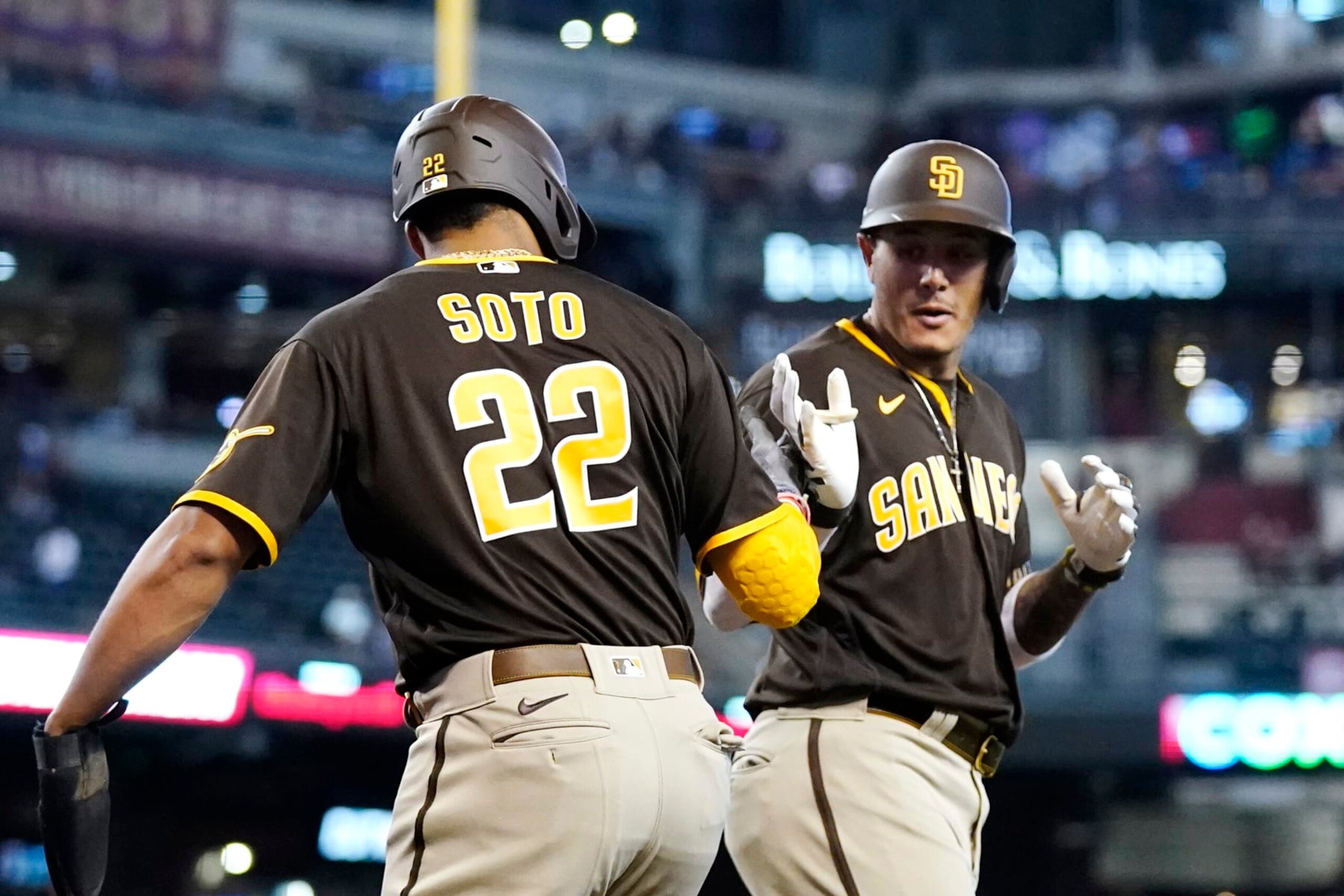 San Diego Padres' Manny Machado, right, celebrates his two-run home run against the Arizona Diamondbacks with Padres' Juan Soto (22) during the first inning of a baseball game in Phoenix, Sunday, Sept. 18, 2022. (AP Photo/Ross D. Franklin)