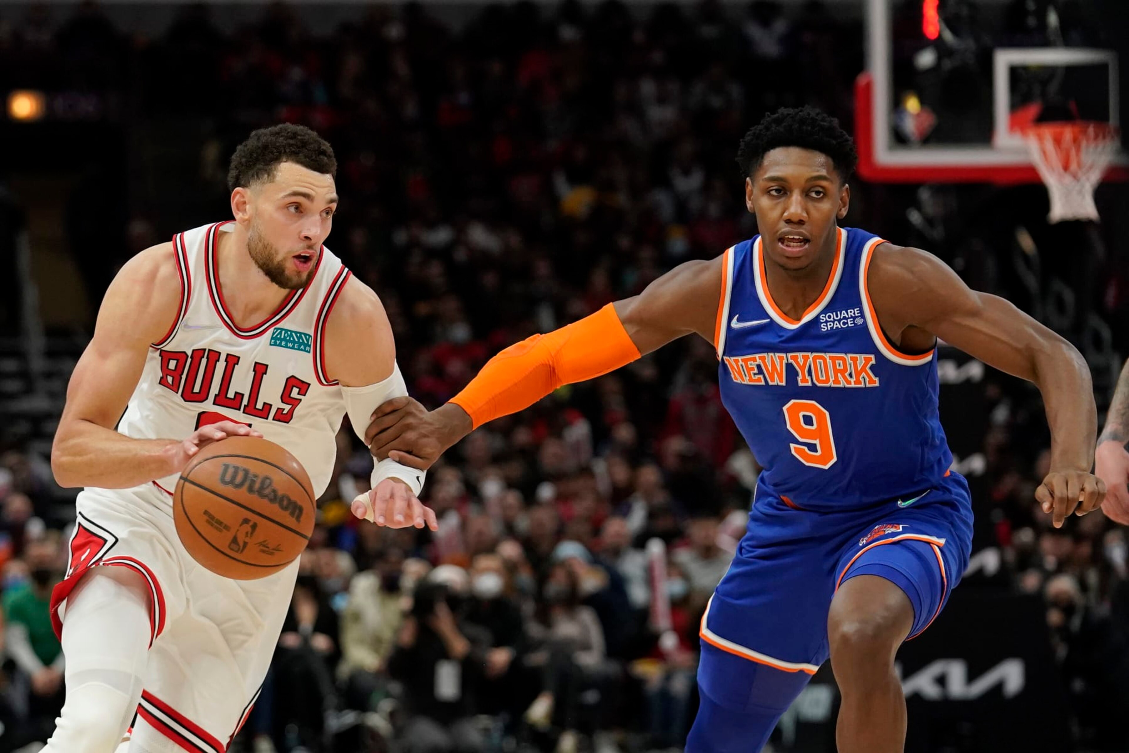 CHICAGO, ILLINOIS - NOVEMBER 21: Zach LaVine #8 of the Chicago Bulls dribbles the ball against RJ Barrett #9 of the New York Knicks in the second half at United Center on November 21, 2021 in Chicago, Illinois. NOTE TO USER: User expressly acknowledges and agrees that, by downloading and or using this photograph, user is consenting to the terms and conditions of the Getty Images License Agreement. (Photo by Patrick McDermott/Getty Images)