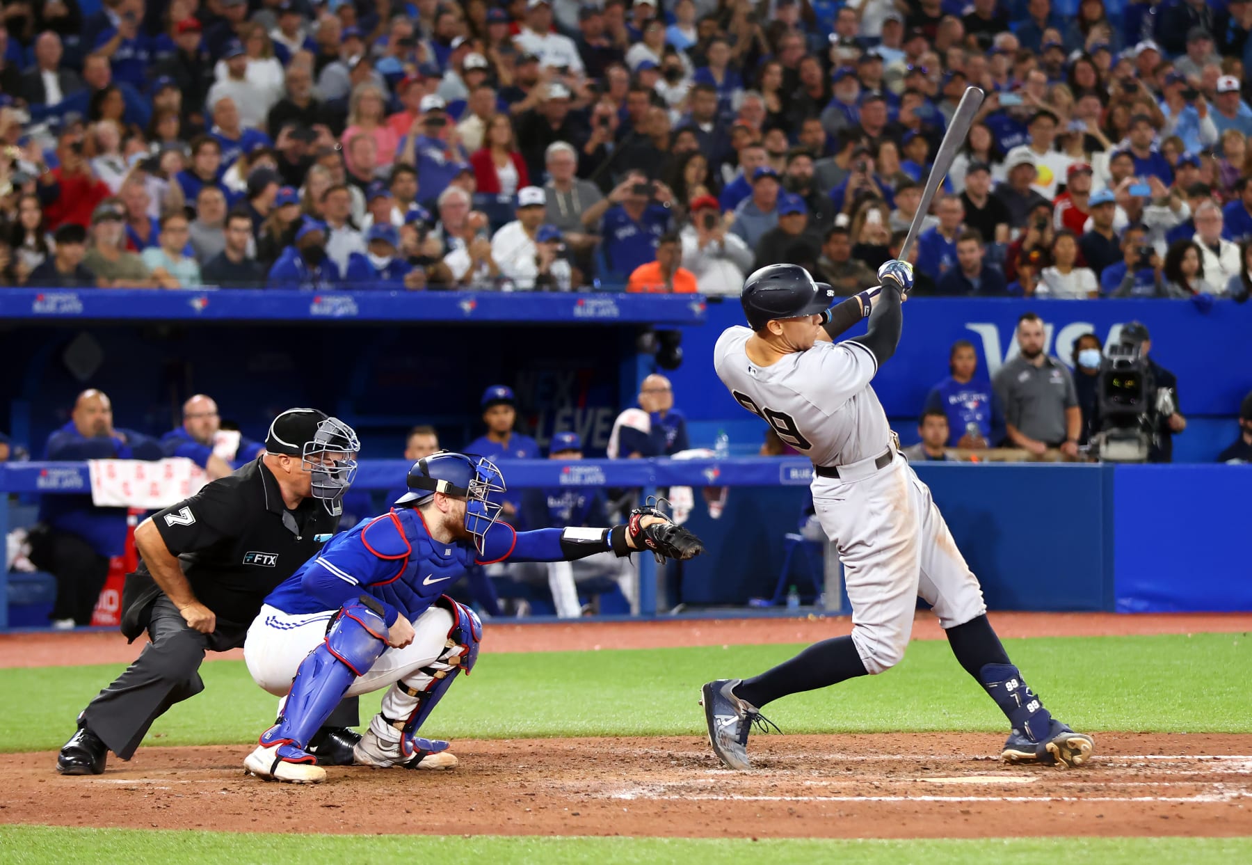 TORONTO, ON - SEPTEMBER 28:  Aaron Judge #99 of the New York Yankees hits his 61st home run of the season in the seventh inning against the Toronto Blue Jays at Rogers Centre on September 28, 2022 in Toronto, Ontario, Canada. Judge has now tied Roger Maris for the American League record.  (Photo by Vaughn Ridley/Getty Images)