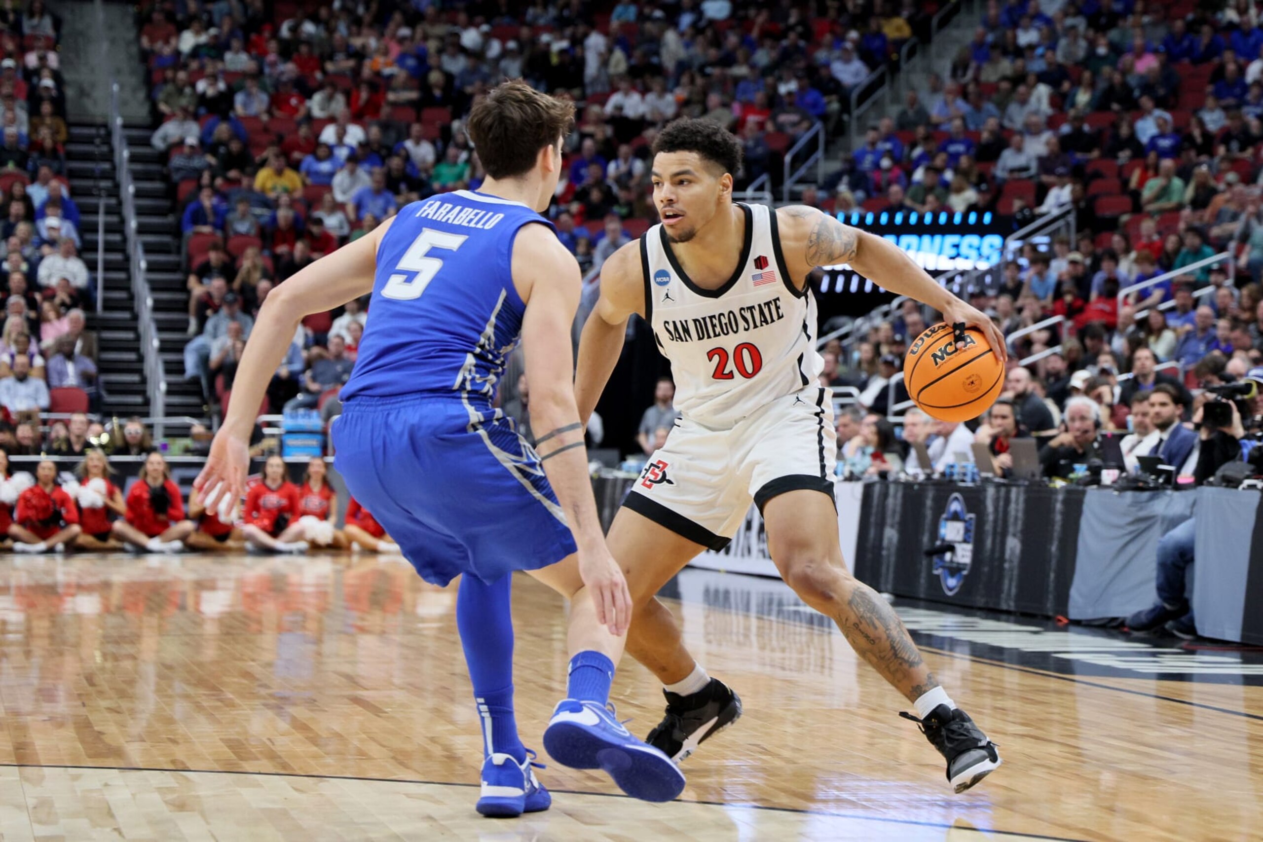 LOUISVILLE, KENTUCKY - MARCH 26: Matt Bradley #20 of the San Diego State Aztecs drives to the basket against Francisco Farabello #5 of the Creighton Bluejays during the first half in the Elite Eight round of the NCAA Men's Basketball Tournament at KFC YUM! Center on March 26, 2023 in Louisville, Kentucky. (Photo by Andy Lyons/Getty Images)