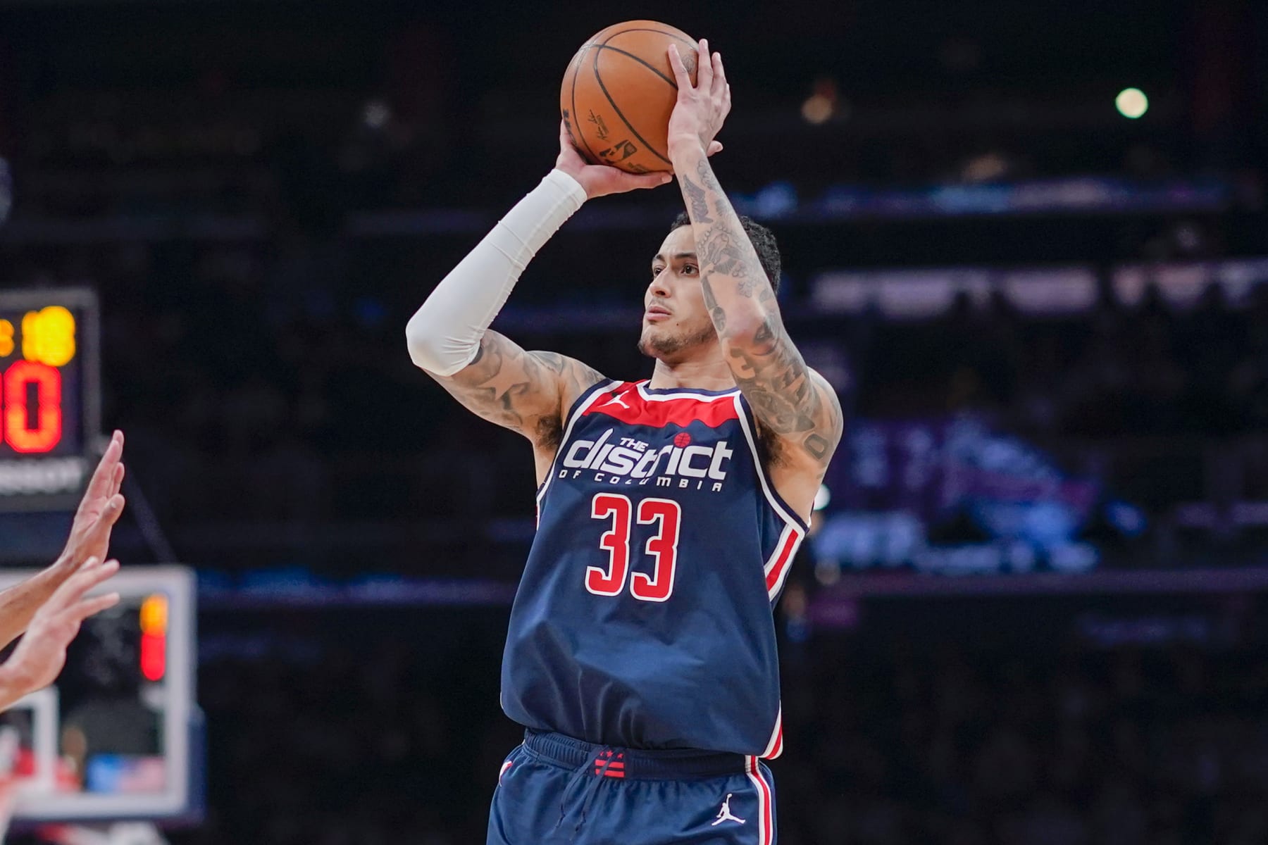 Washington Wizards forward Kyle Kuzma (33) shoots against the Sacramento Kings during the first half of an NBA basketball game, Saturday, March 18, 2023, in Washington. (AP Photo/Jess Rapfogel)