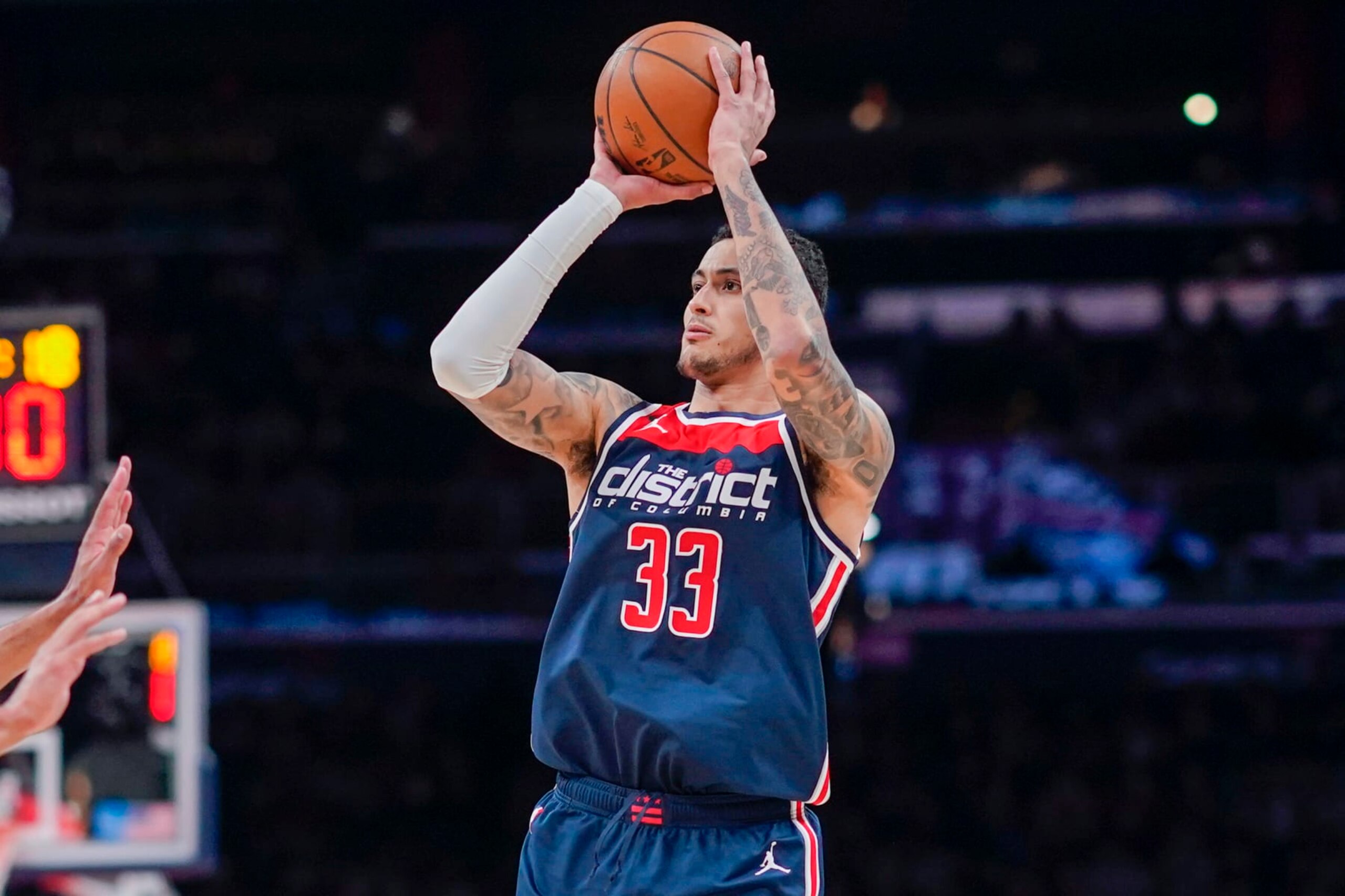 Washington Wizards forward Kyle Kuzma (33) shoots against the Sacramento Kings during the first half of an NBA basketball game, Saturday, March 18, 2023, in Washington. (AP Photo/Jess Rapfogel)