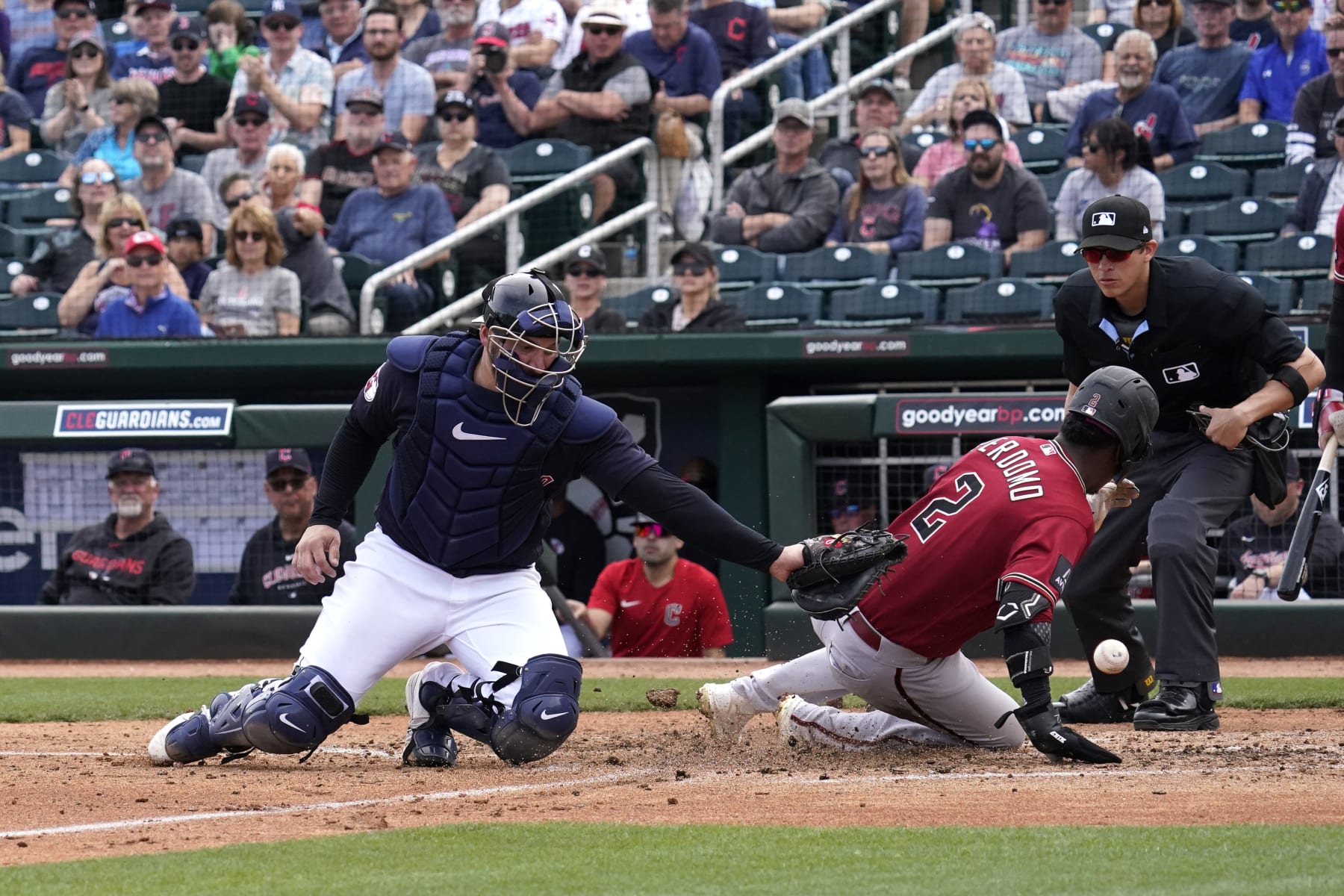 GOODYEAR, ARIZONA - MARCH 05: Geraldo Perdomo #2 of the Arizona Diamondbacks slides into home safely in the top of the forth inning, as ball gets past Mike Zunino #10 of the Cleveland Guardians at Goodyear Ballpark on March 05, 2023 in Goodyear, Arizona. (Photo by Patrick Mulligan/Getty Images)