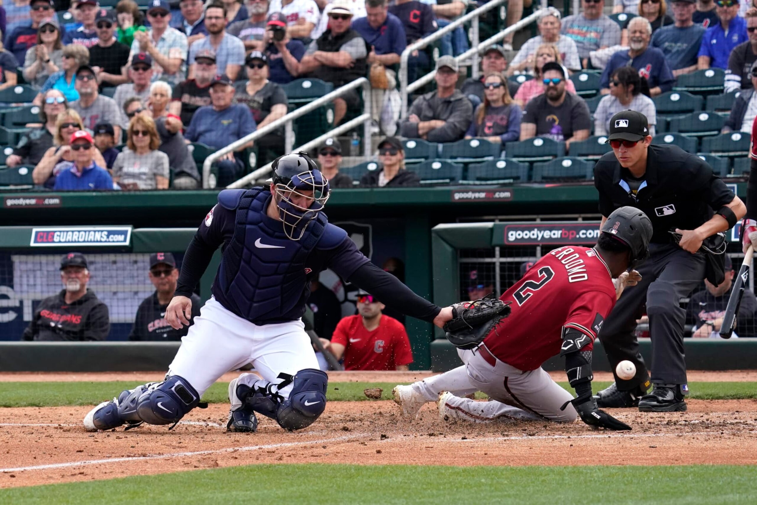 GOODYEAR, ARIZONA - MARCH 05: Geraldo Perdomo #2 of the Arizona Diamondbacks slides into home safely in the top of the forth inning, as ball gets past Mike Zunino #10 of the Cleveland Guardians at Goodyear Ballpark on March 05, 2023 in Goodyear, Arizona. (Photo by Patrick Mulligan/Getty Images)