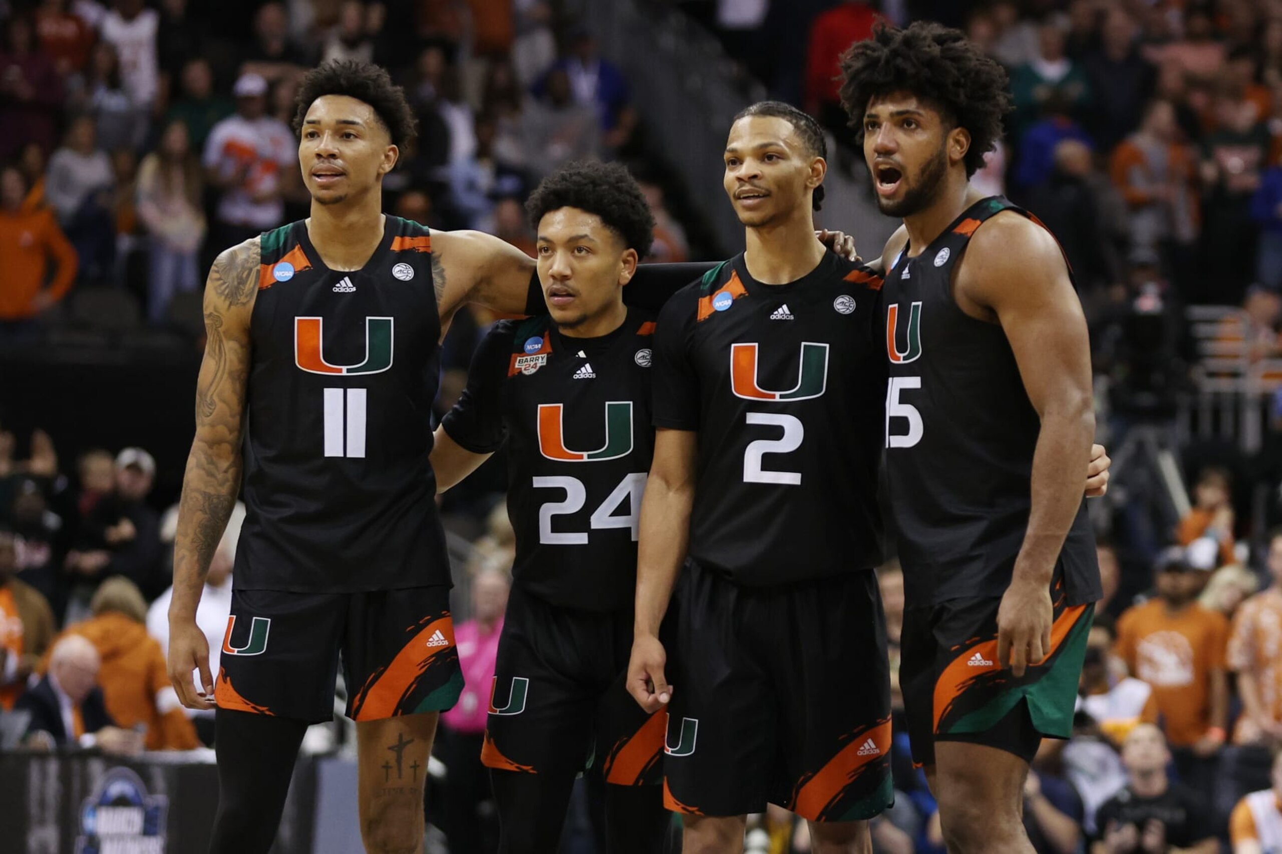 Miami's Jordan Miller (11), Nijel Pack (24), Isaiah Wong (2) and Norchad Omier (15)